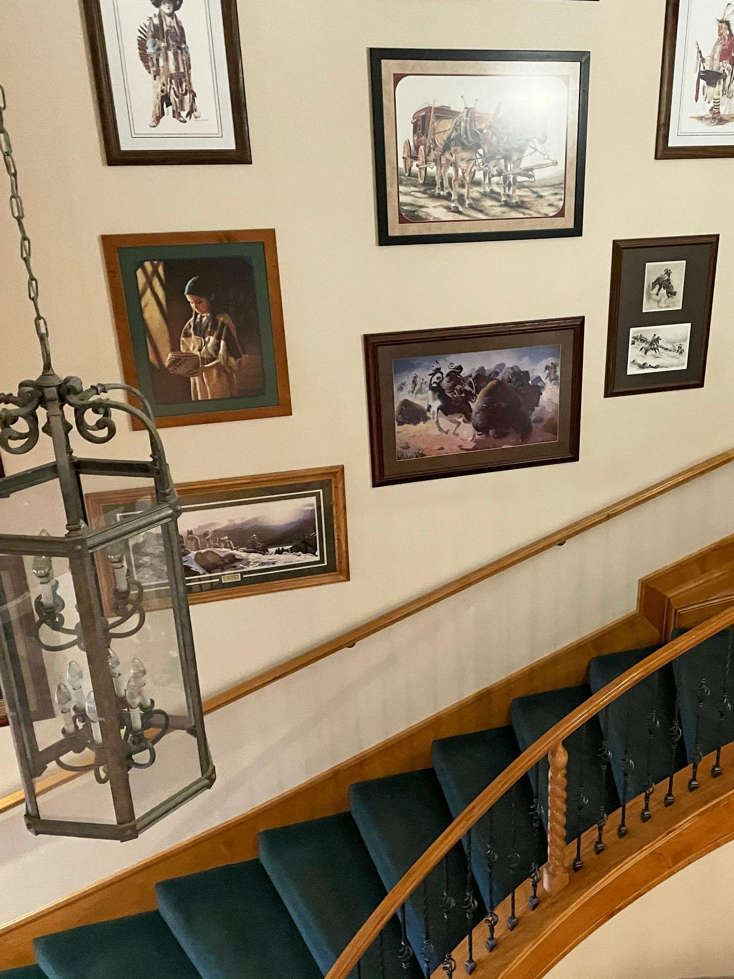 A staircase with artwork on the wall at the Snuggle Inn.