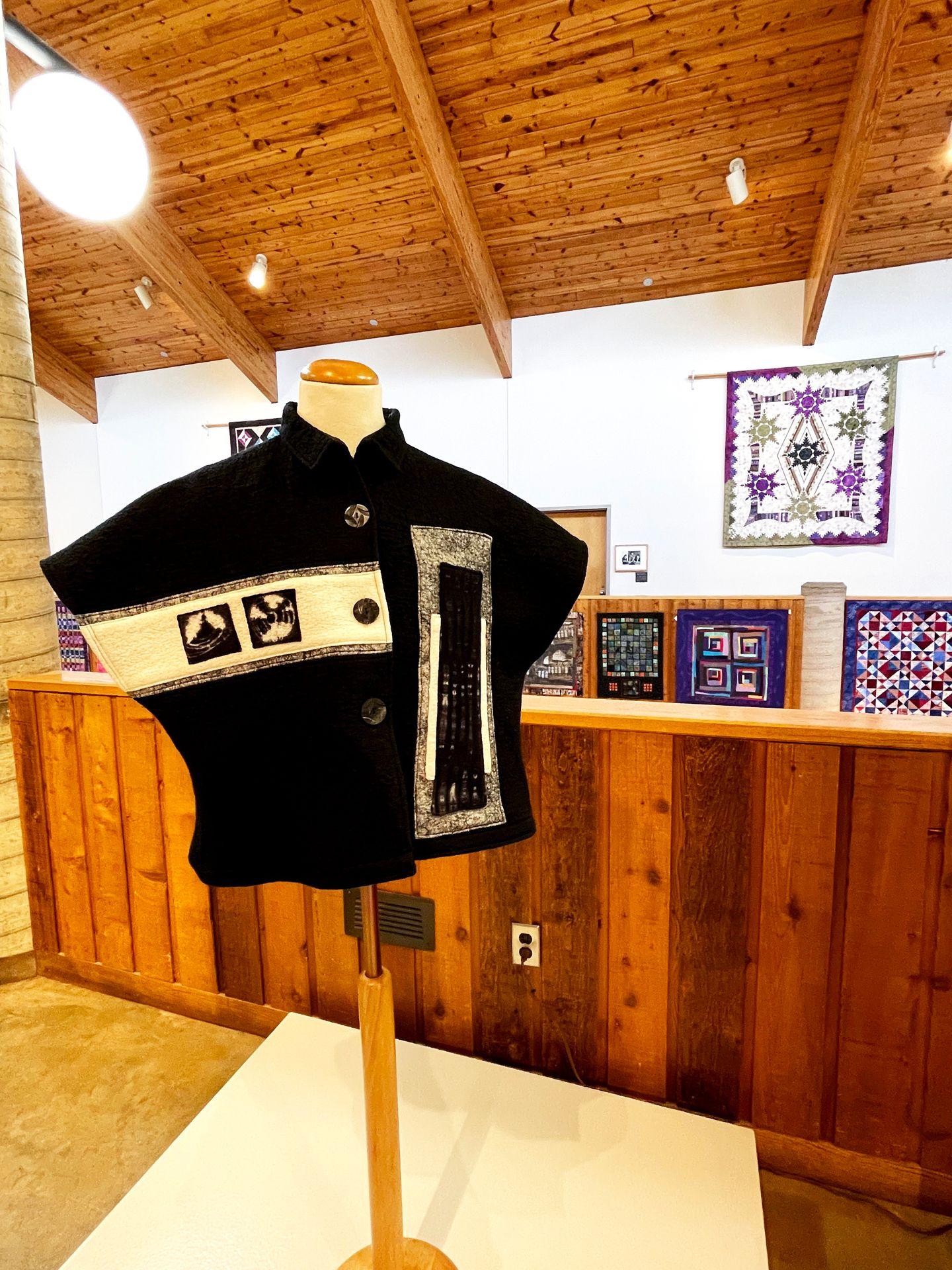 A black and white garment on display at the Folk Arts Center.