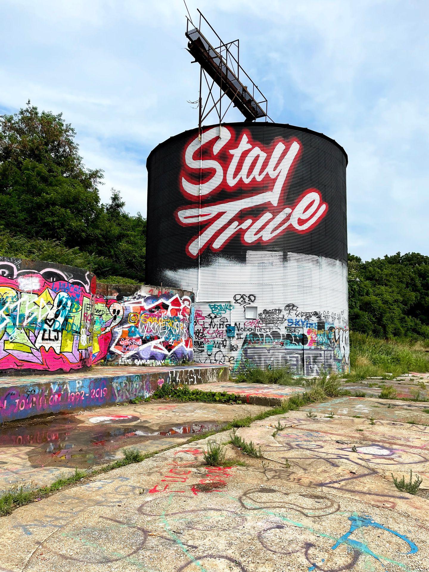 A painted water tower that reads "Stay True" in the River Arts District.