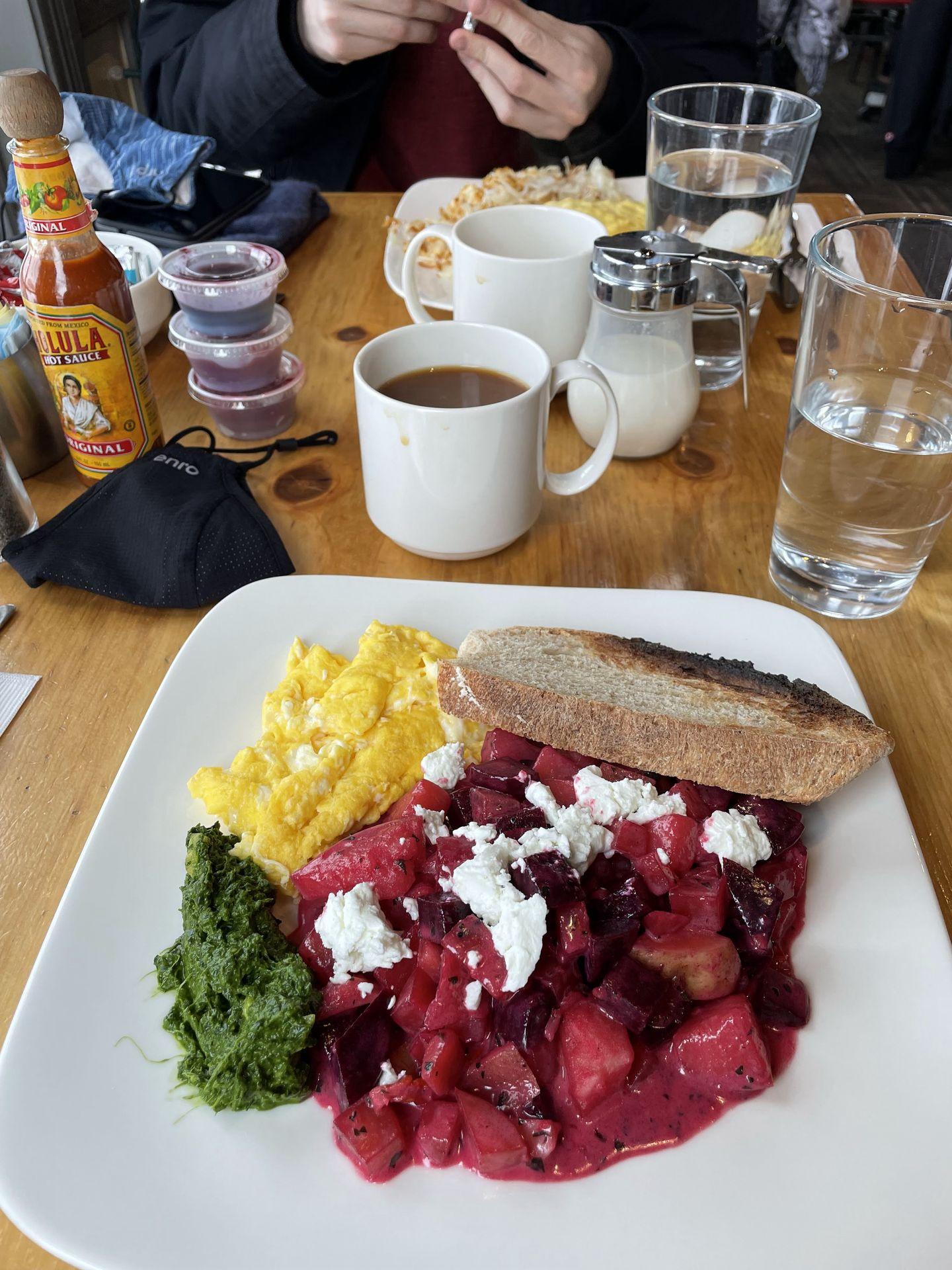 Brunch at Bread and Salt. The plate includes scrambled eggs, a beet and potato hash with feta cheese and toast.