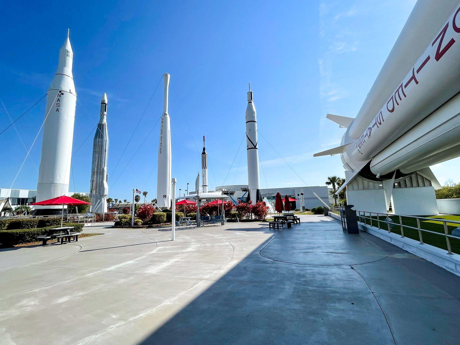 The rocket park in the Kennedy Space Center. Five rockets are standing upright and one rocket is on it's side.