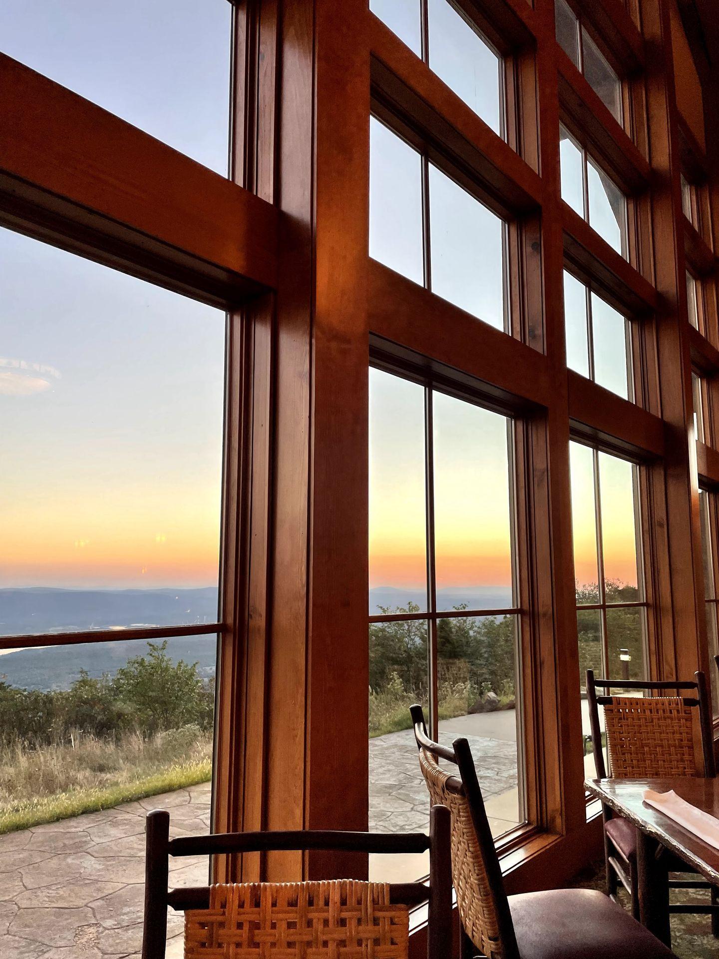 Looking through the windows of the Mount Magazine Lodge at a sunset.