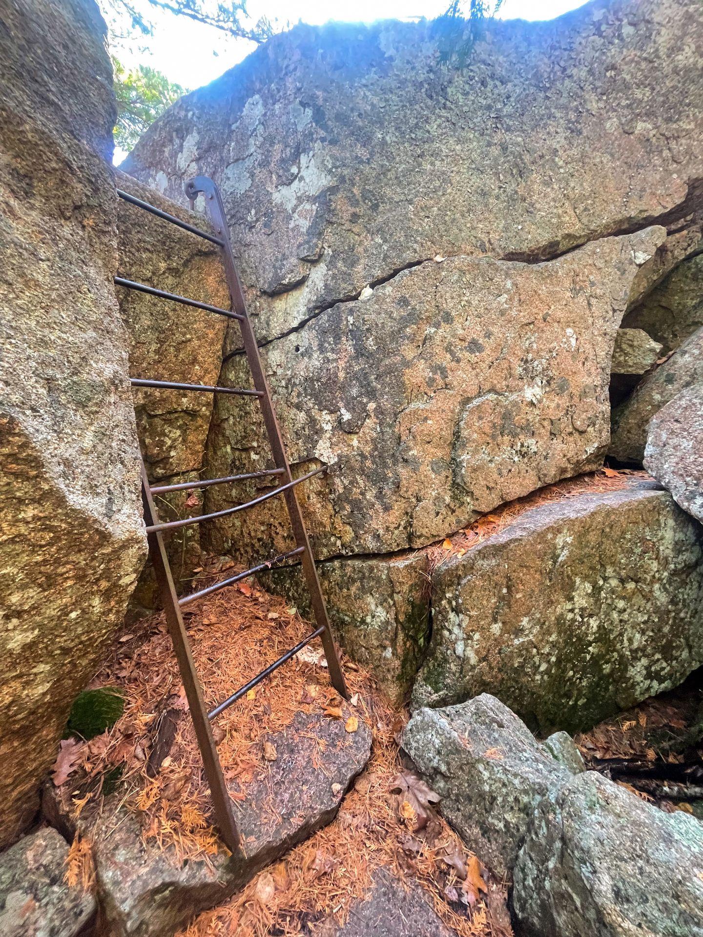 A ladder up against giant boulders leading up to Dorr Mountain