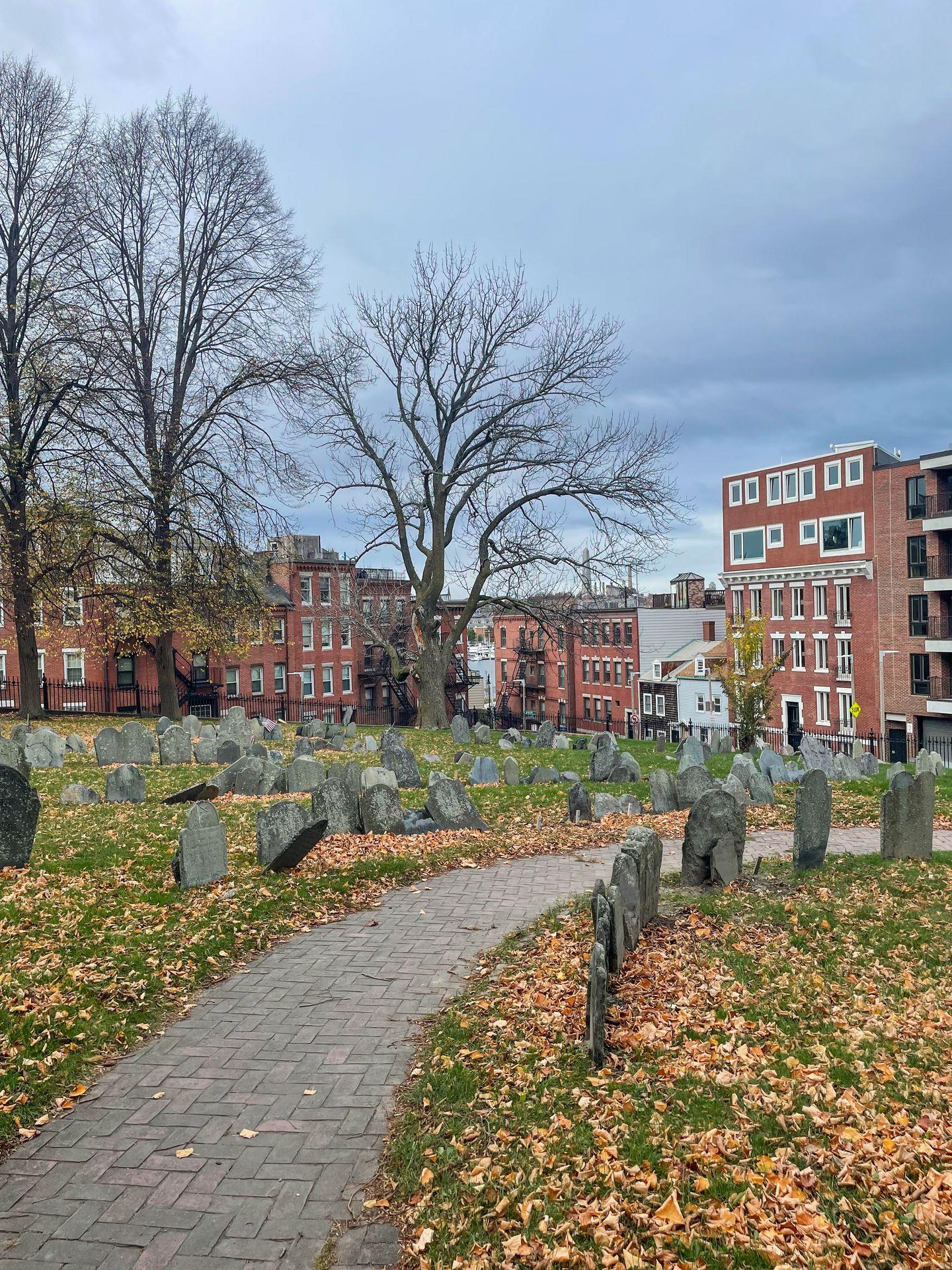 Several historic graves along a path in the Copp's Hill Burying Ground