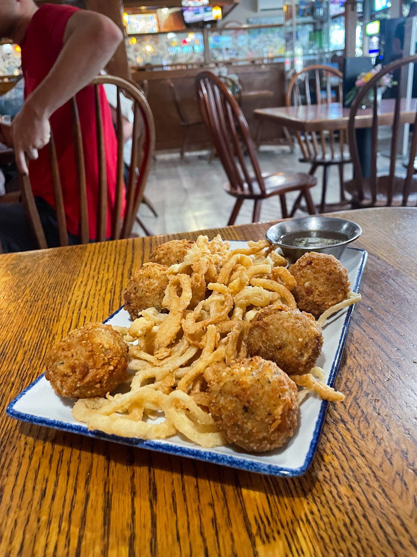 A plate of fried cheese balls and onion strings from Kingston Kitchen.