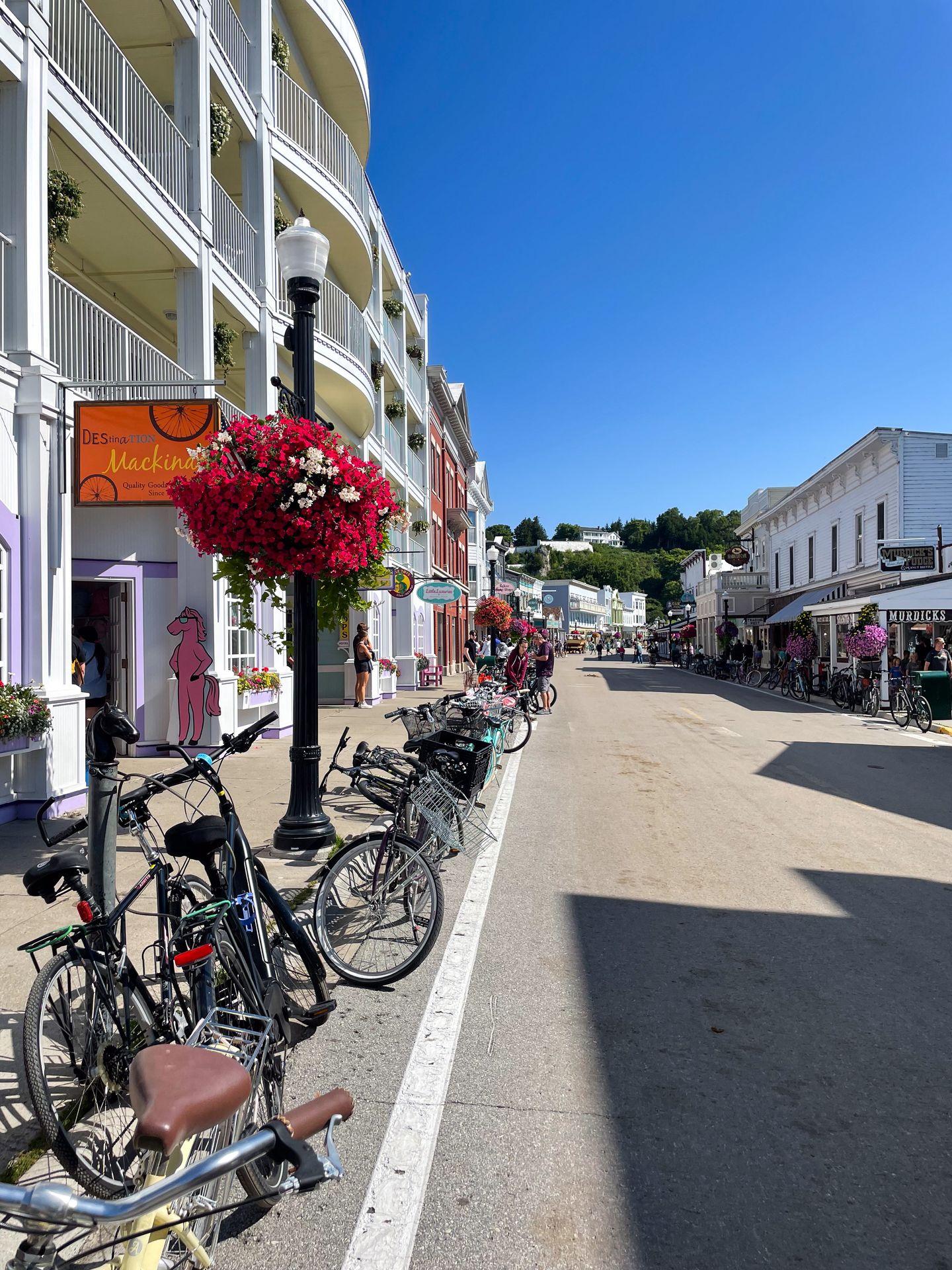 A street with bikes parked along the street in Downtown Mackinac Island.