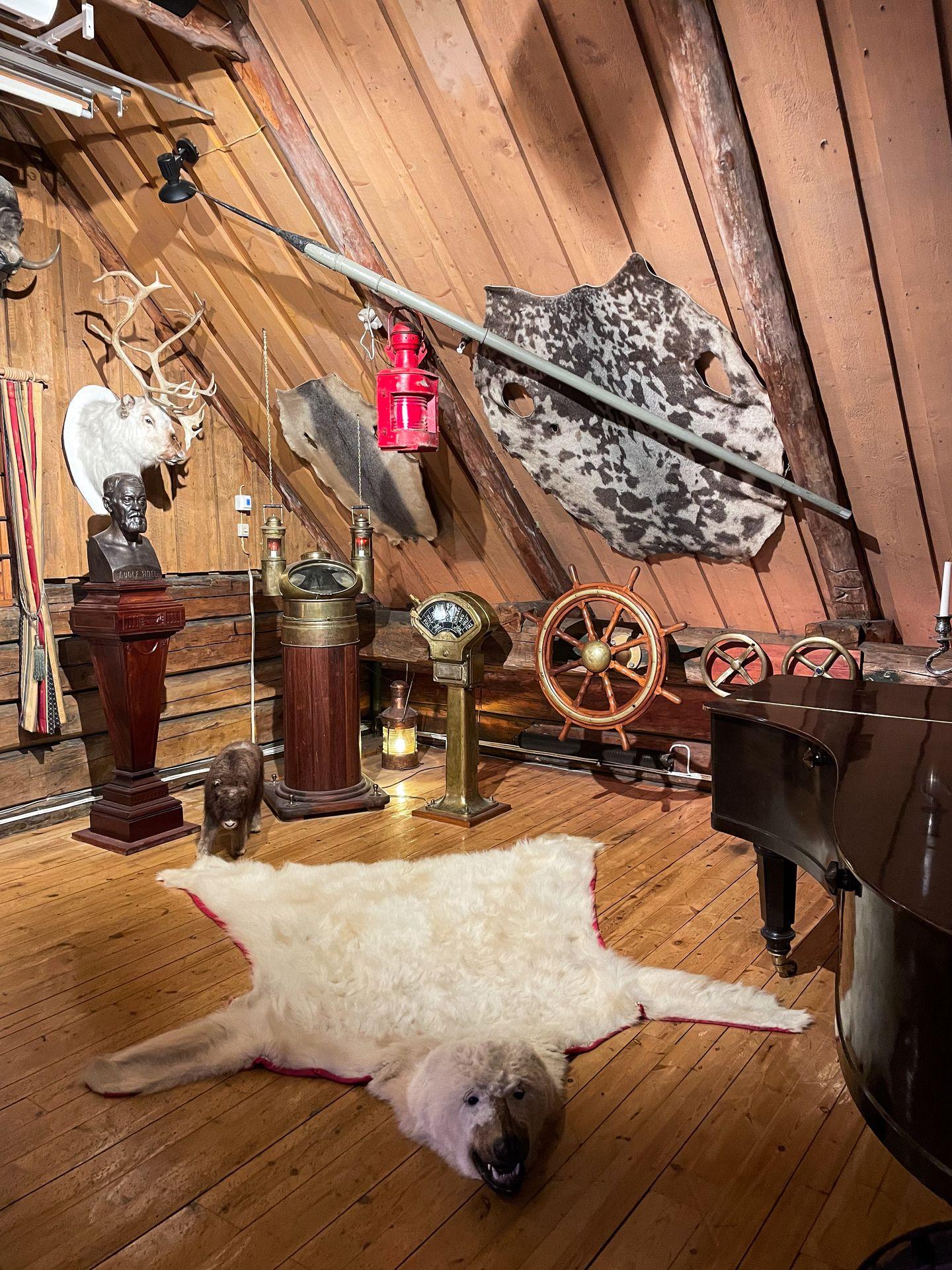 A Polar Bear rug, ship steering wheels and other items inside the Polar Museum.