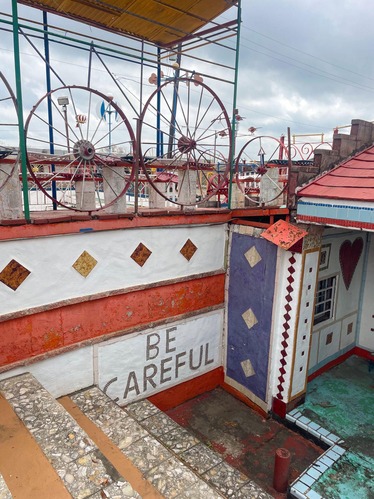 Inside of The Orange Show Monument. The wall reads 'Be Careful'