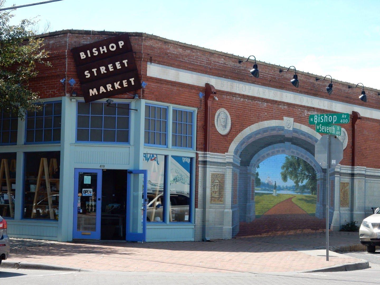 The exterior of the Bishop Street Market. The shop is on a corner and there is a mural on the side.