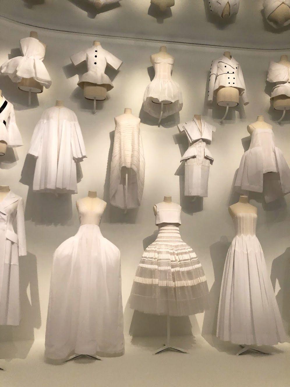 A wall full of white Dior Dresses from a special exhibition at the Dallas Museum of Art.