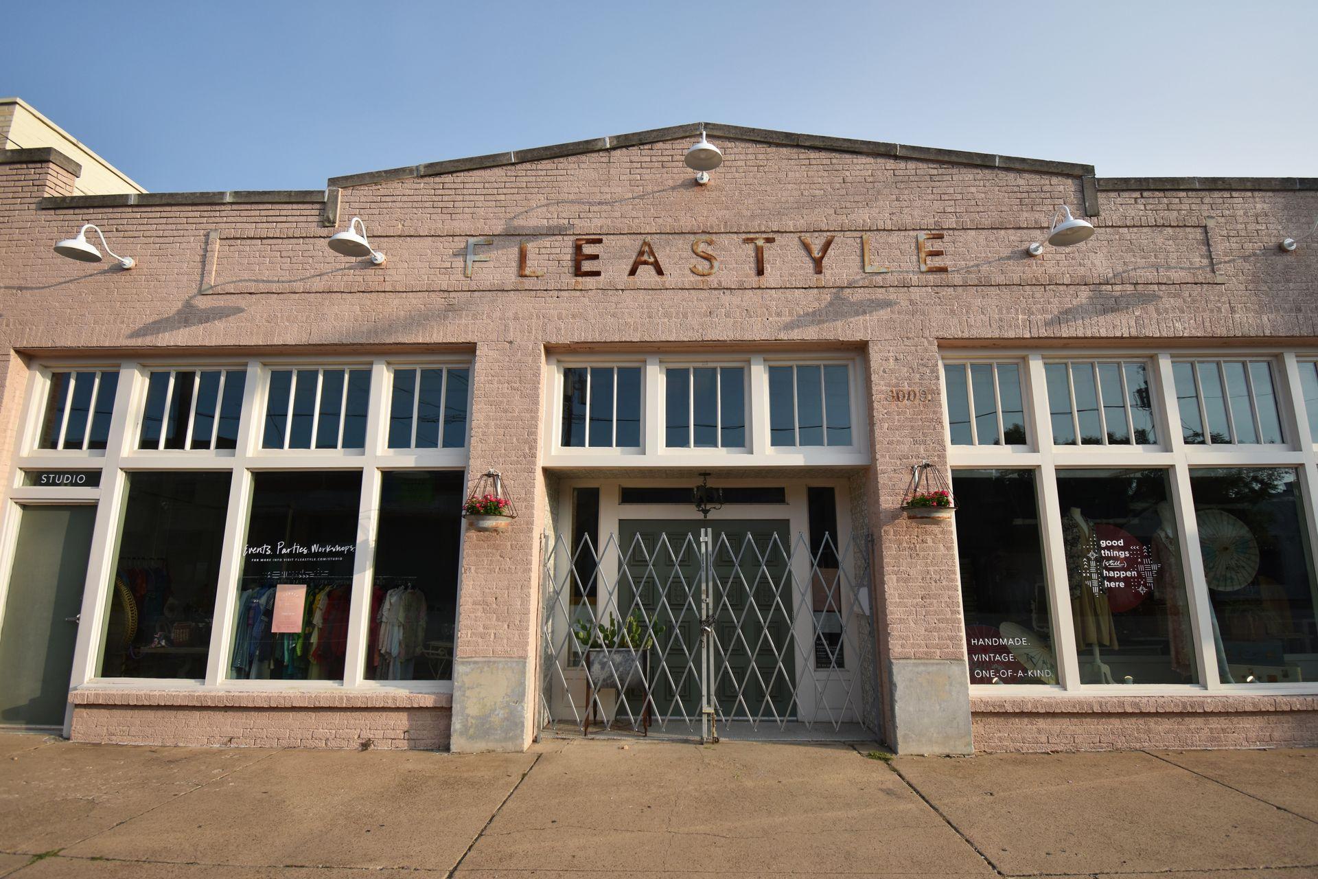 The exterior of Flea Style. The building is made of brick and the Flea Style letters have a vintage-feel.