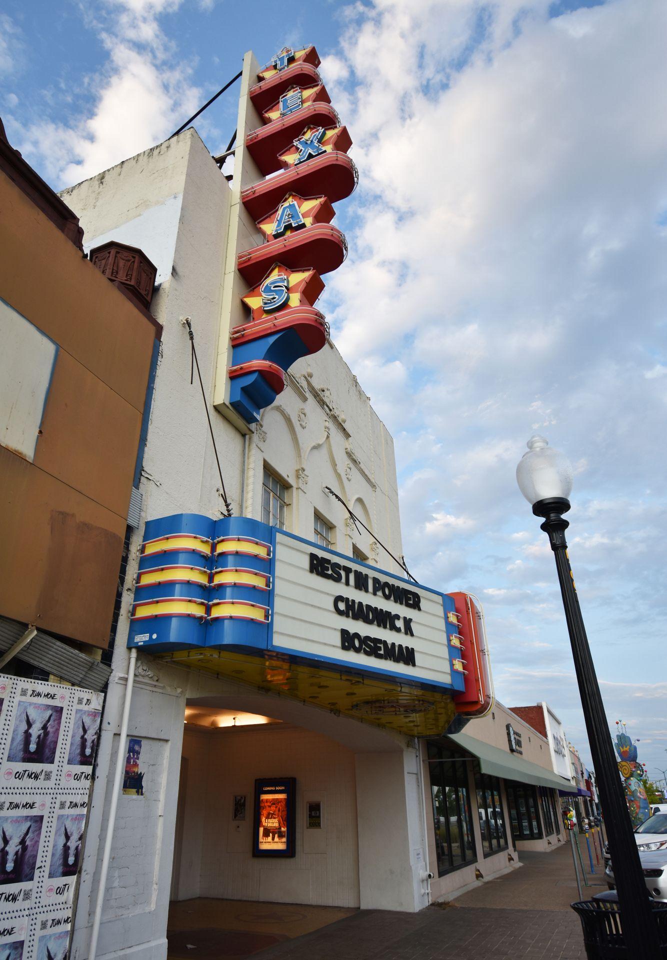 The white Texas Theater with Texas written in colorful letters at the top.