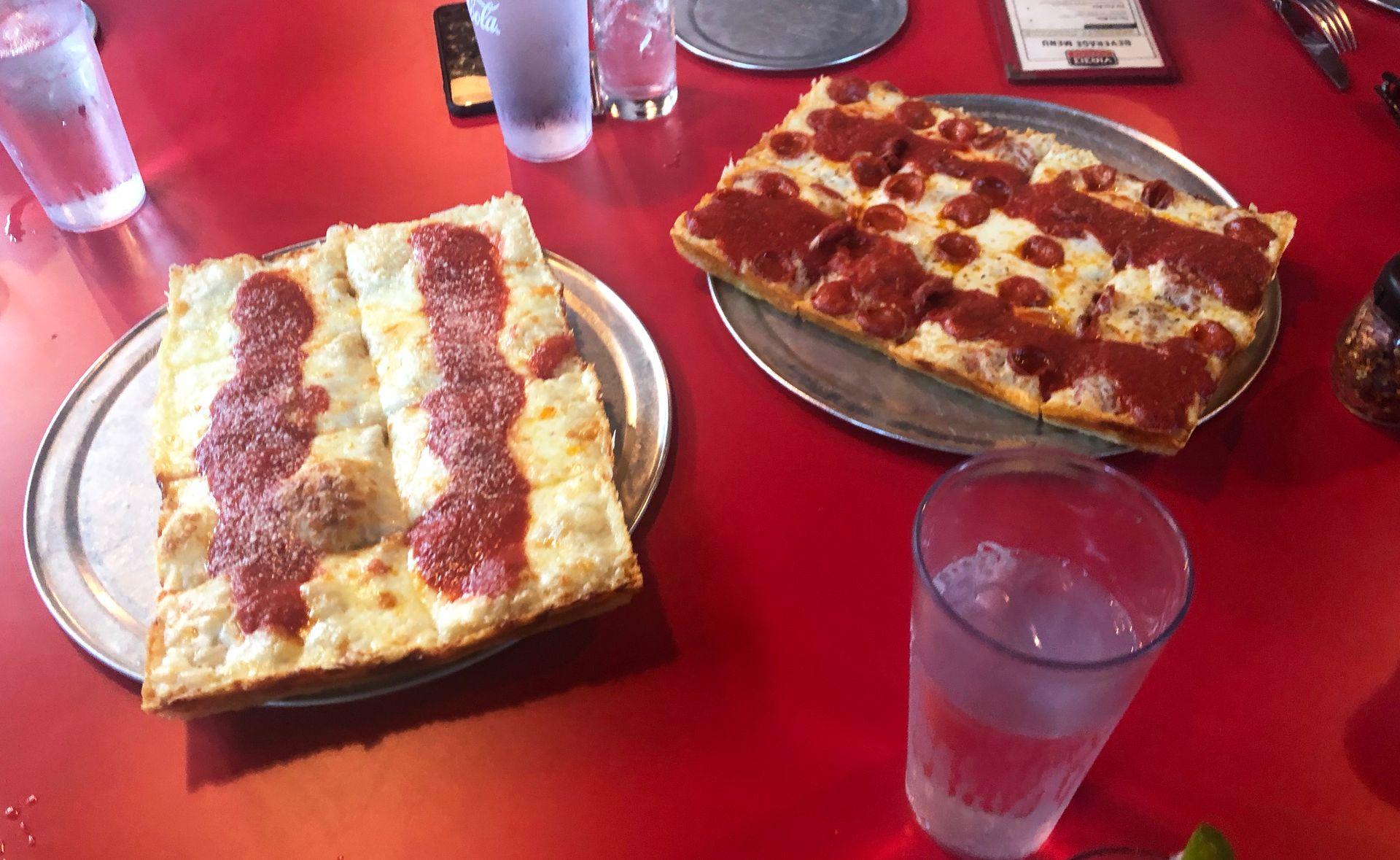 Two plates of detriot-style pizza from Via 313.