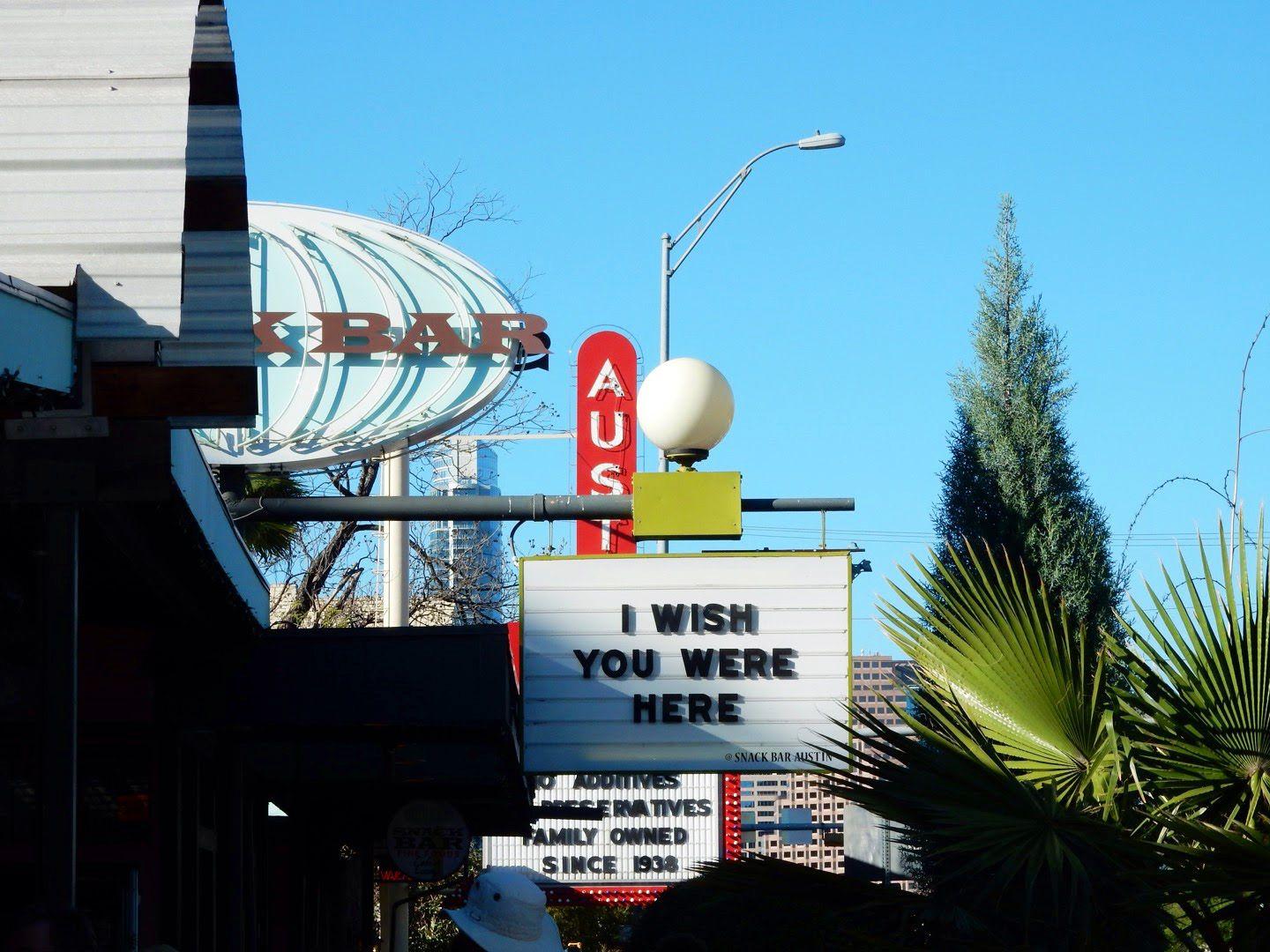 A sign on South Congress Ave that reads "I Wish You Were Here"