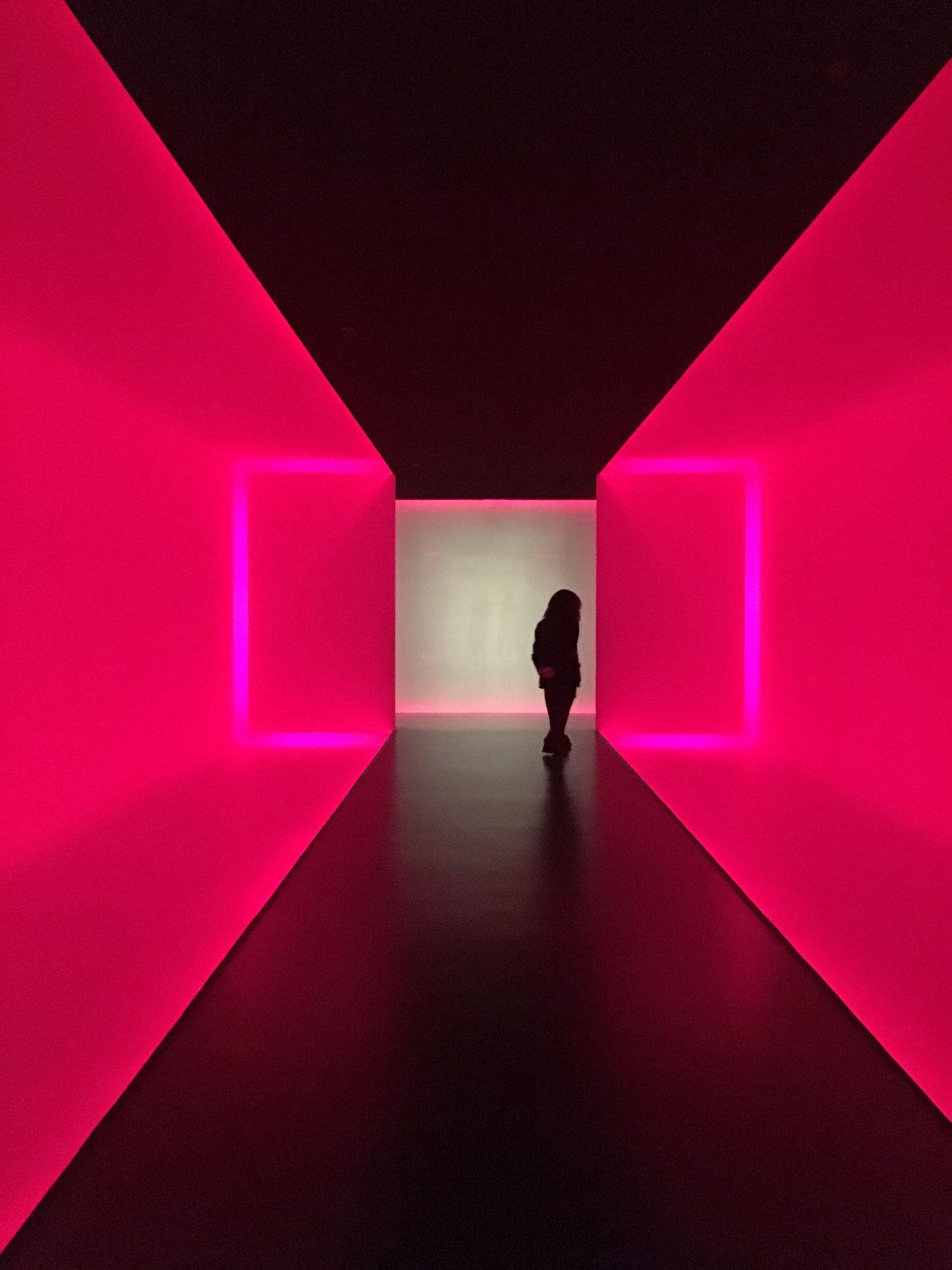 A hallway with pink light designed by James Turrell inside the Museum of Fine Arts.