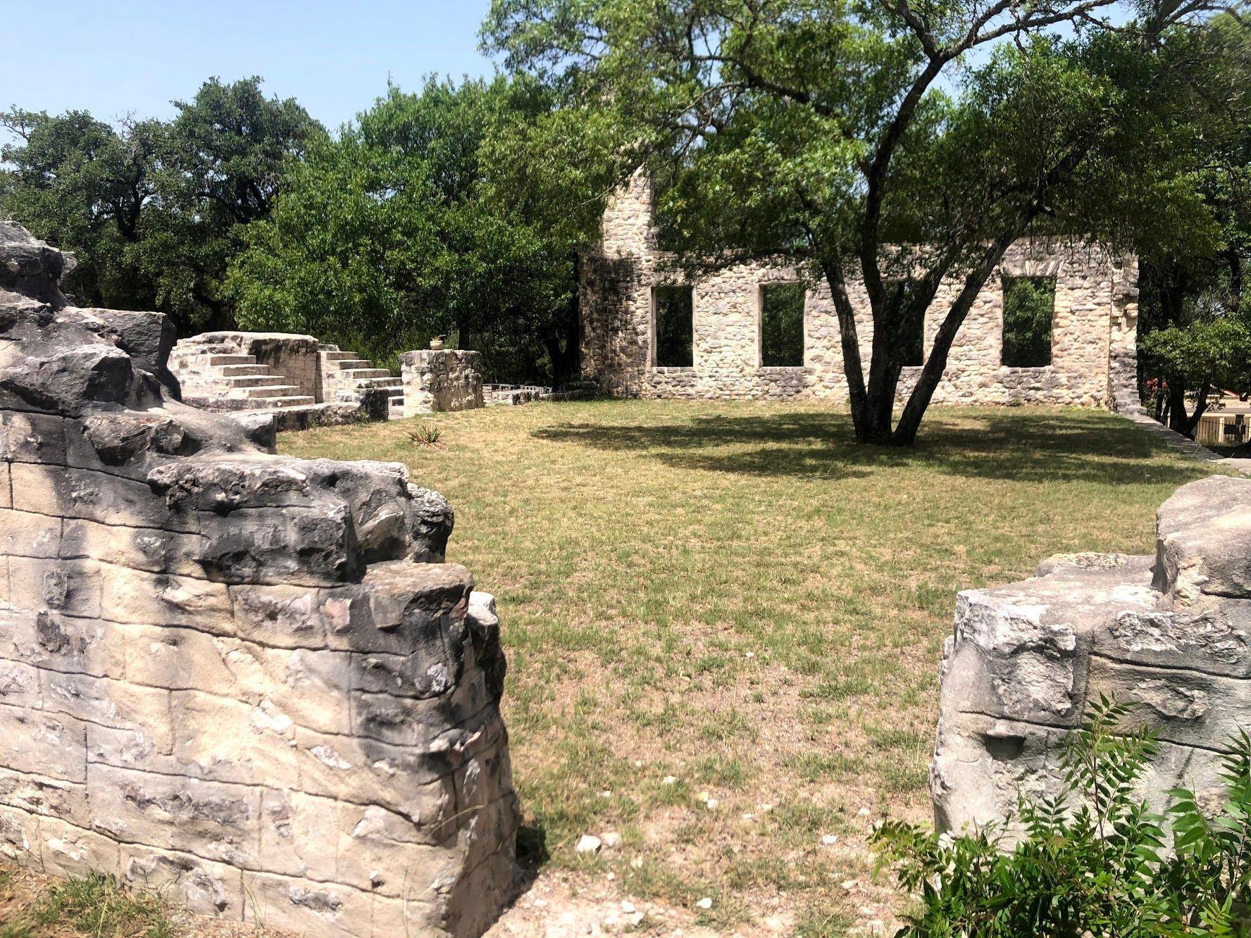 Ruins of a former college at Salado. A tree grow in between the ruins of some buildings.