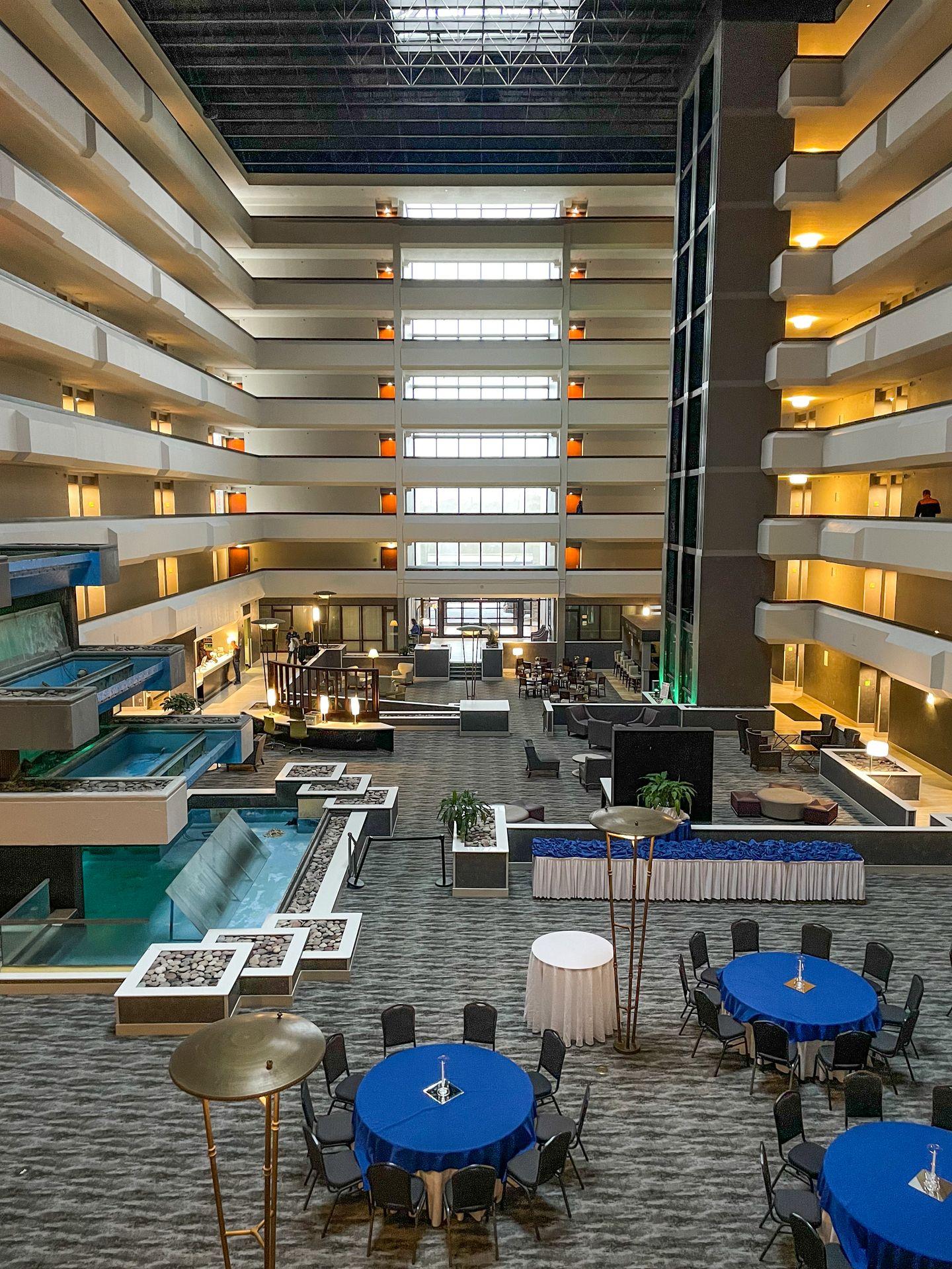 A tall lobby surrounded by hotel rooms at Holiday Inn Beaumont Plaza