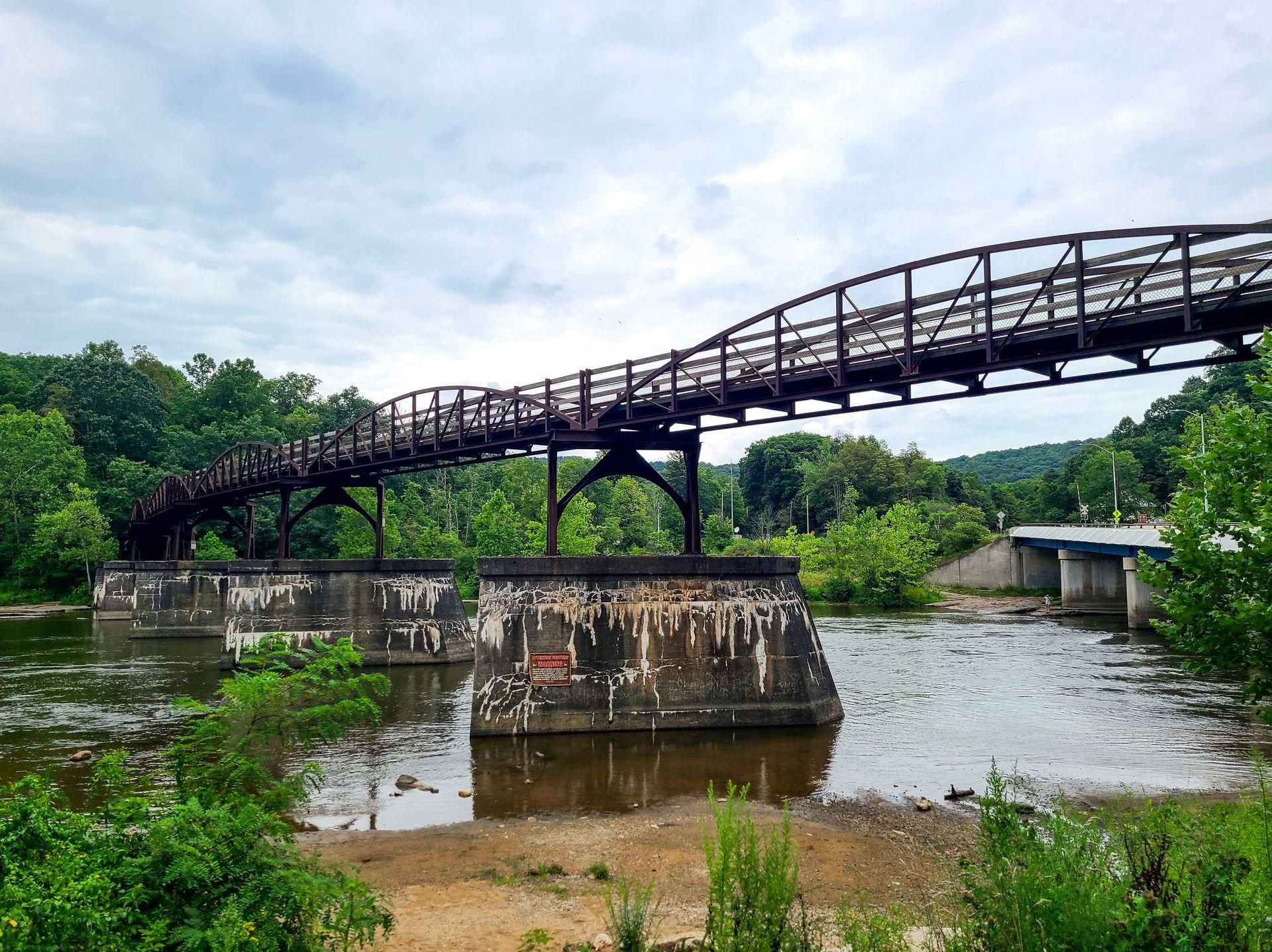 A bike and walking bridge raised over the Youghiogheny River in downtown Ohiopyle.