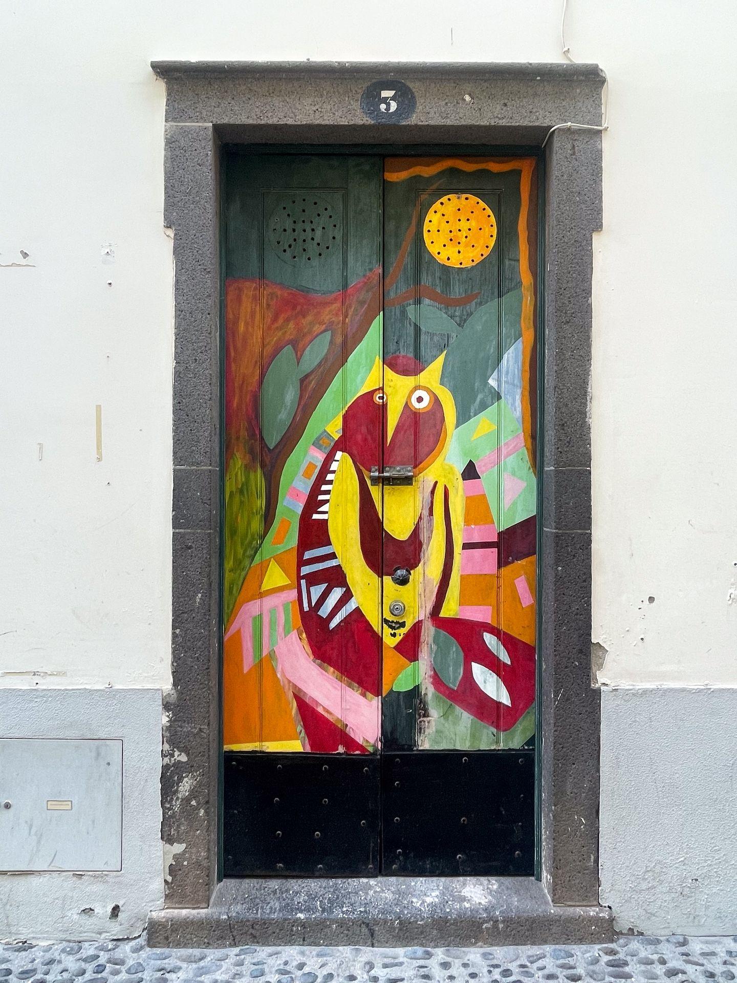 A door painted with colorful abstract art.