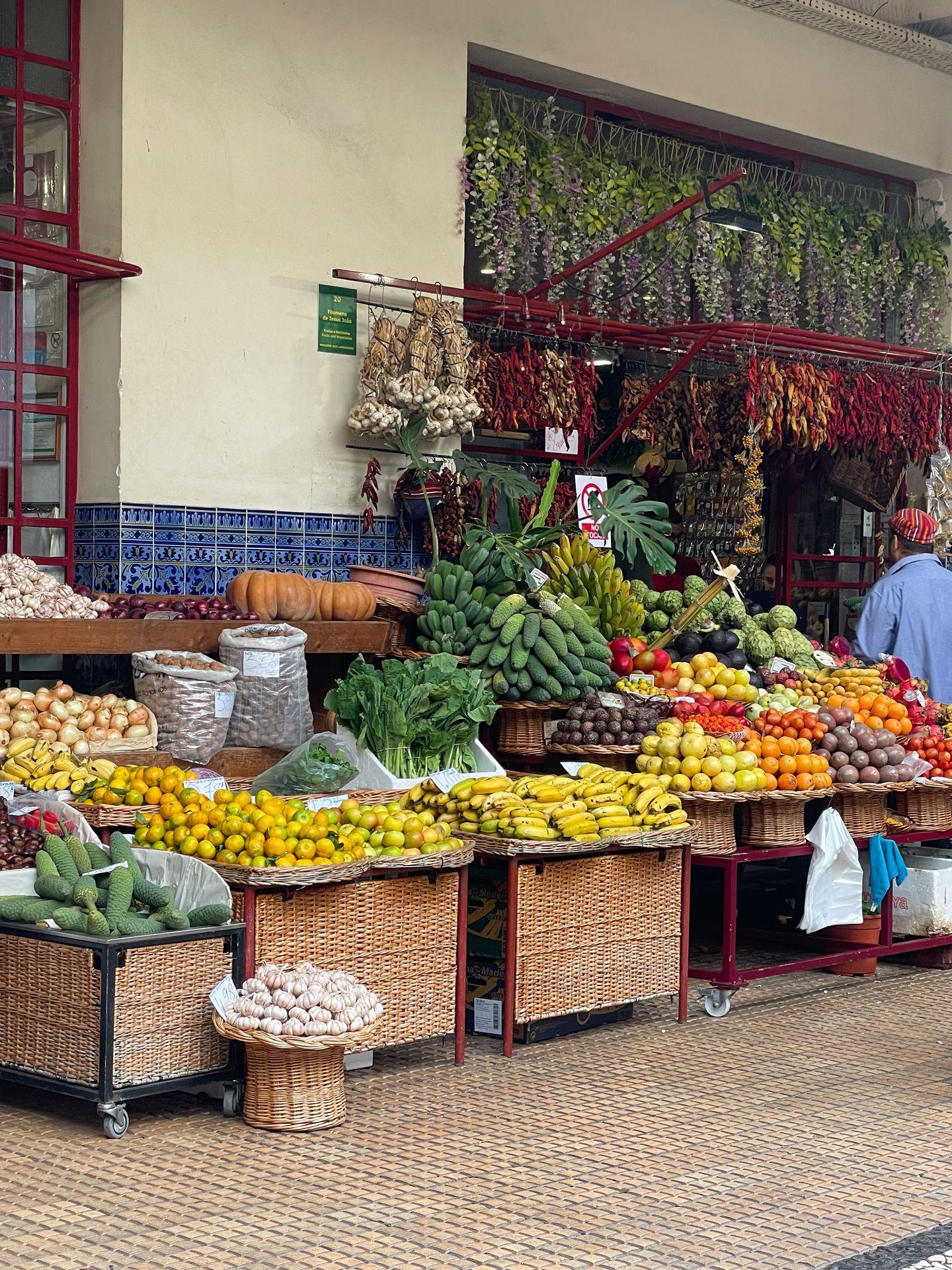 A stand full of colorful fruits at the Funchal Farmers Market