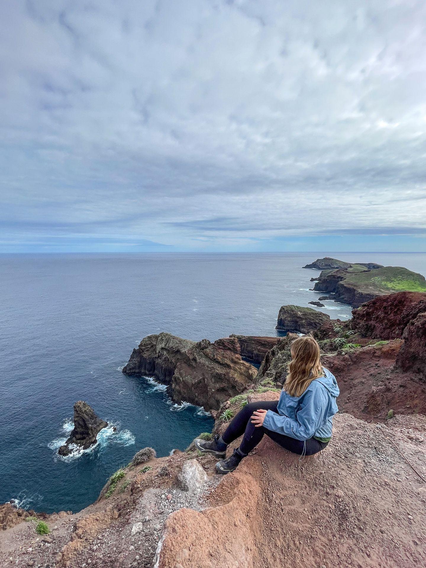 Lydia sitting and looking out at the view from Ponta de Sao Lourenco