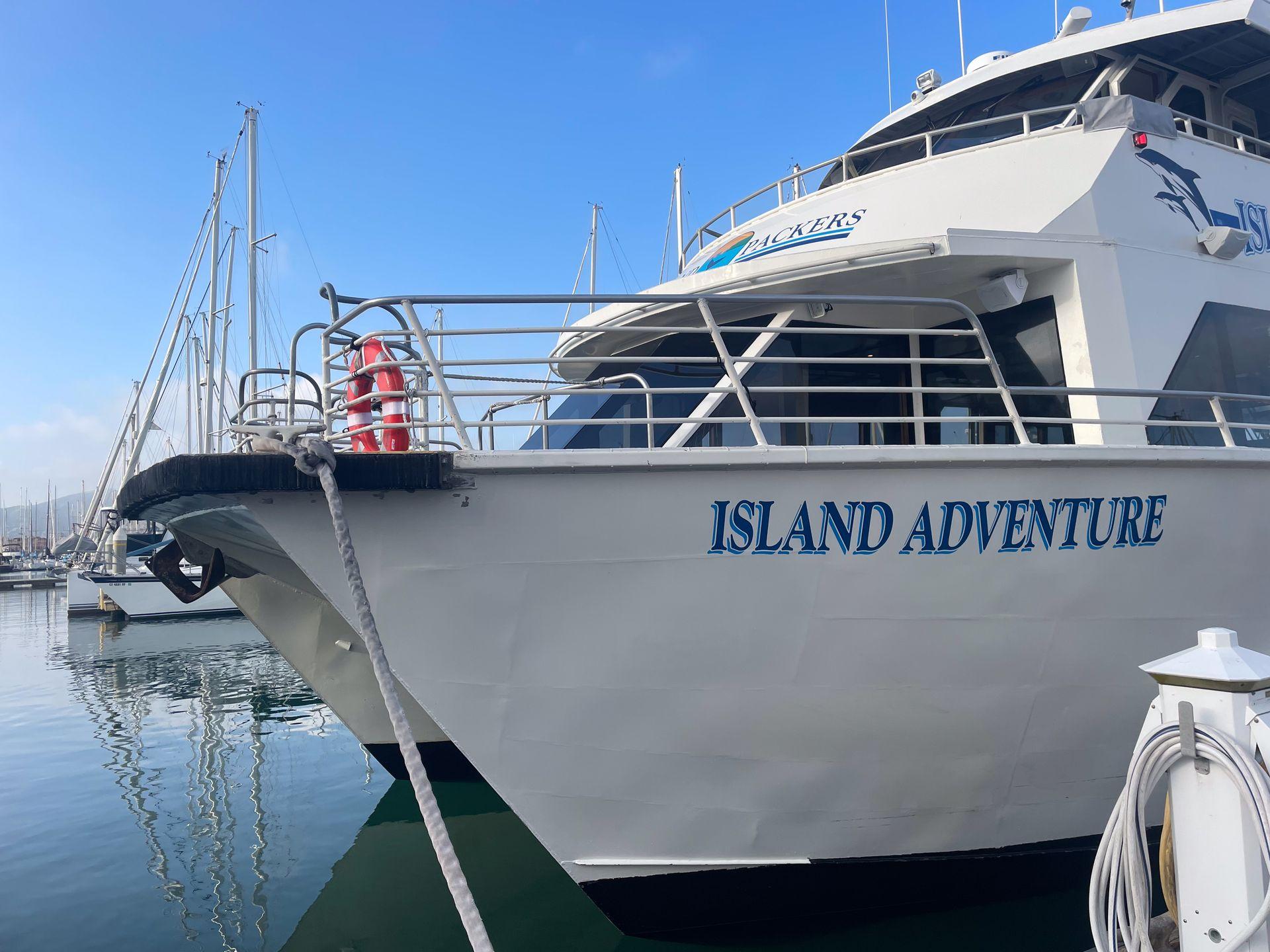 A boat labeled 'Island Adventure' sitting at the dock