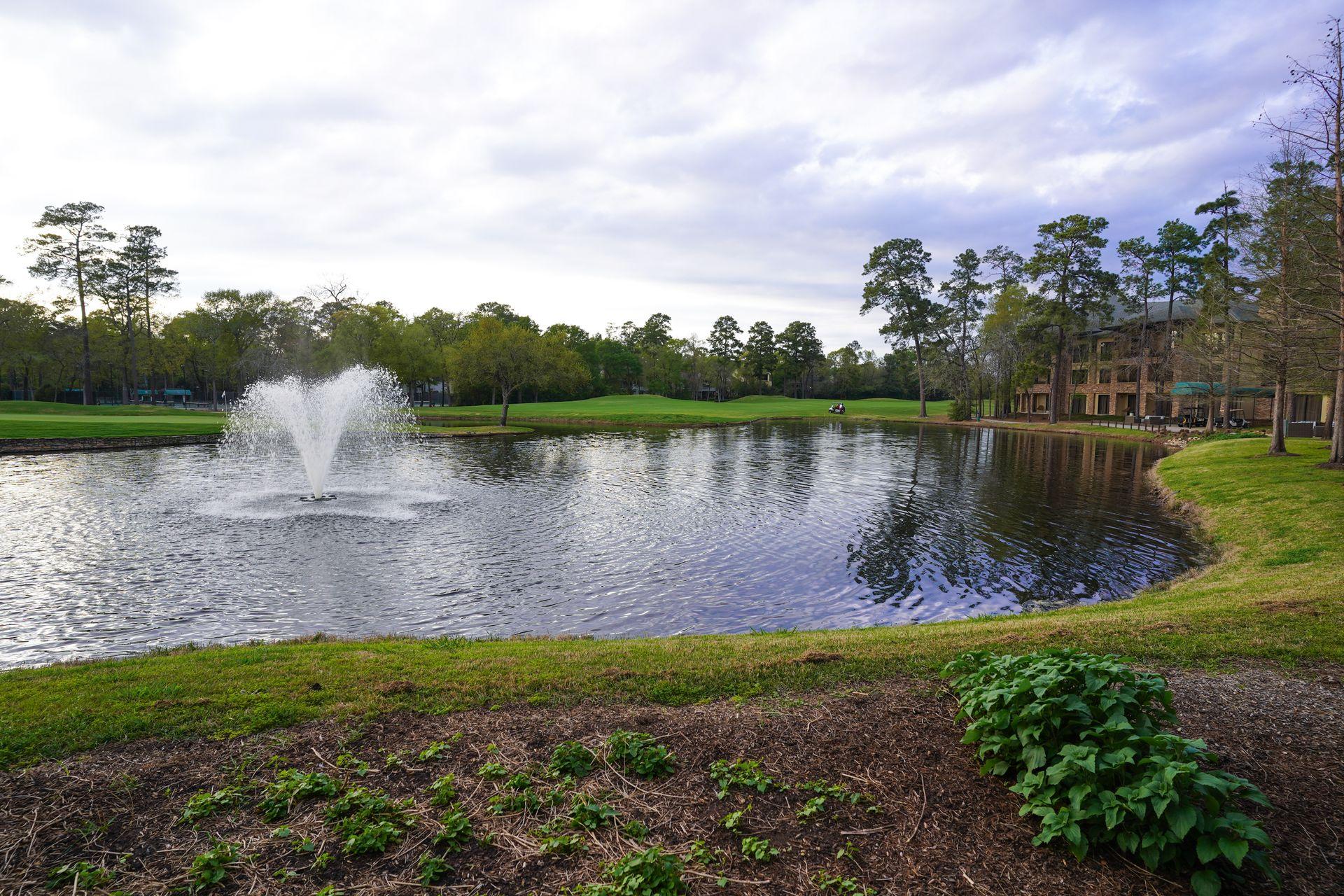 A lake with a water fountain at The Woodlands Resort