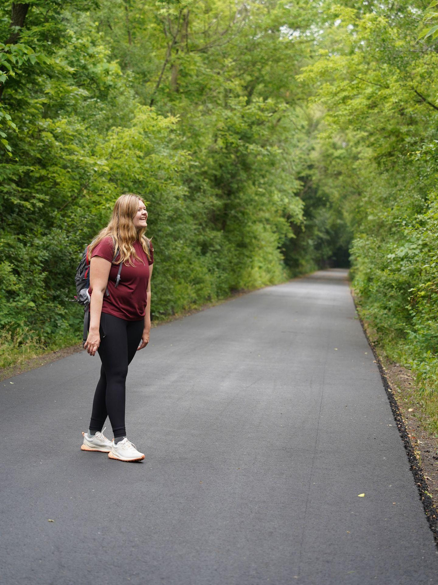 Lydia hiking on a paved path in Minnesota