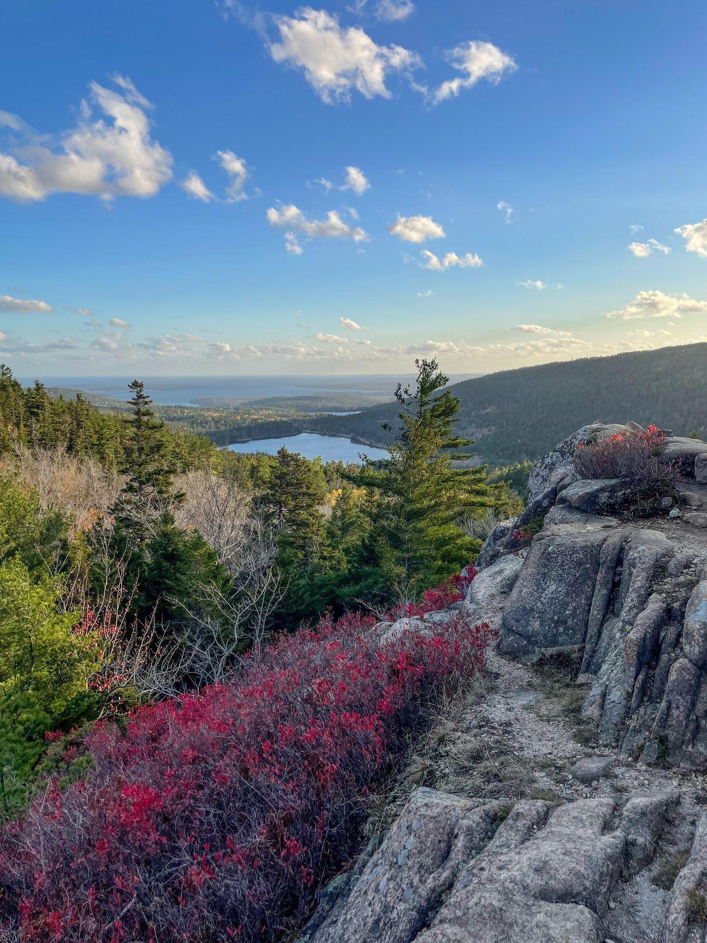A mountain with a lake in the distance seen from the Parkman Mountain Loop