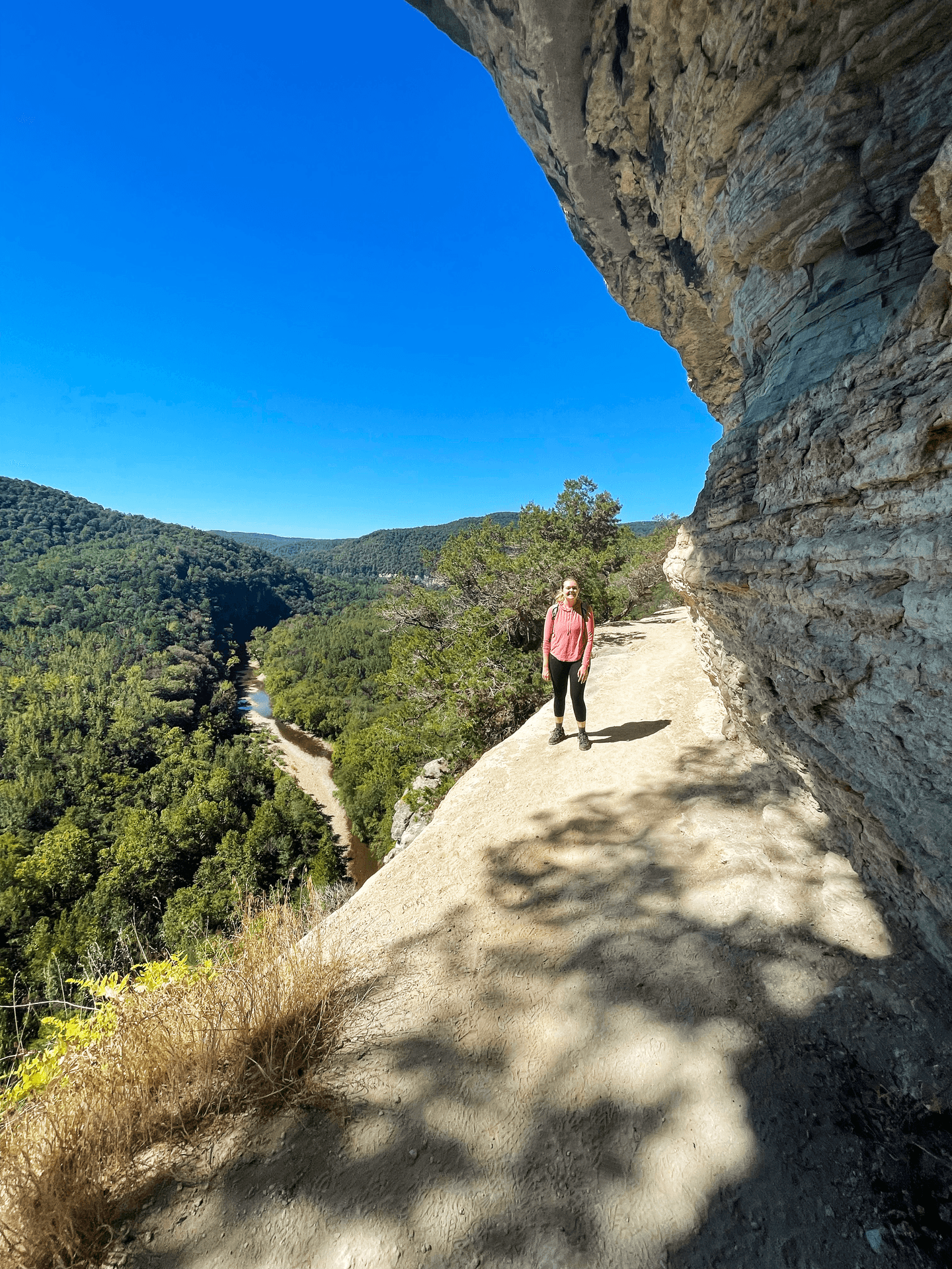 Lydia standing on Goat Bluff with a view of the Buffalo National River below to the left.