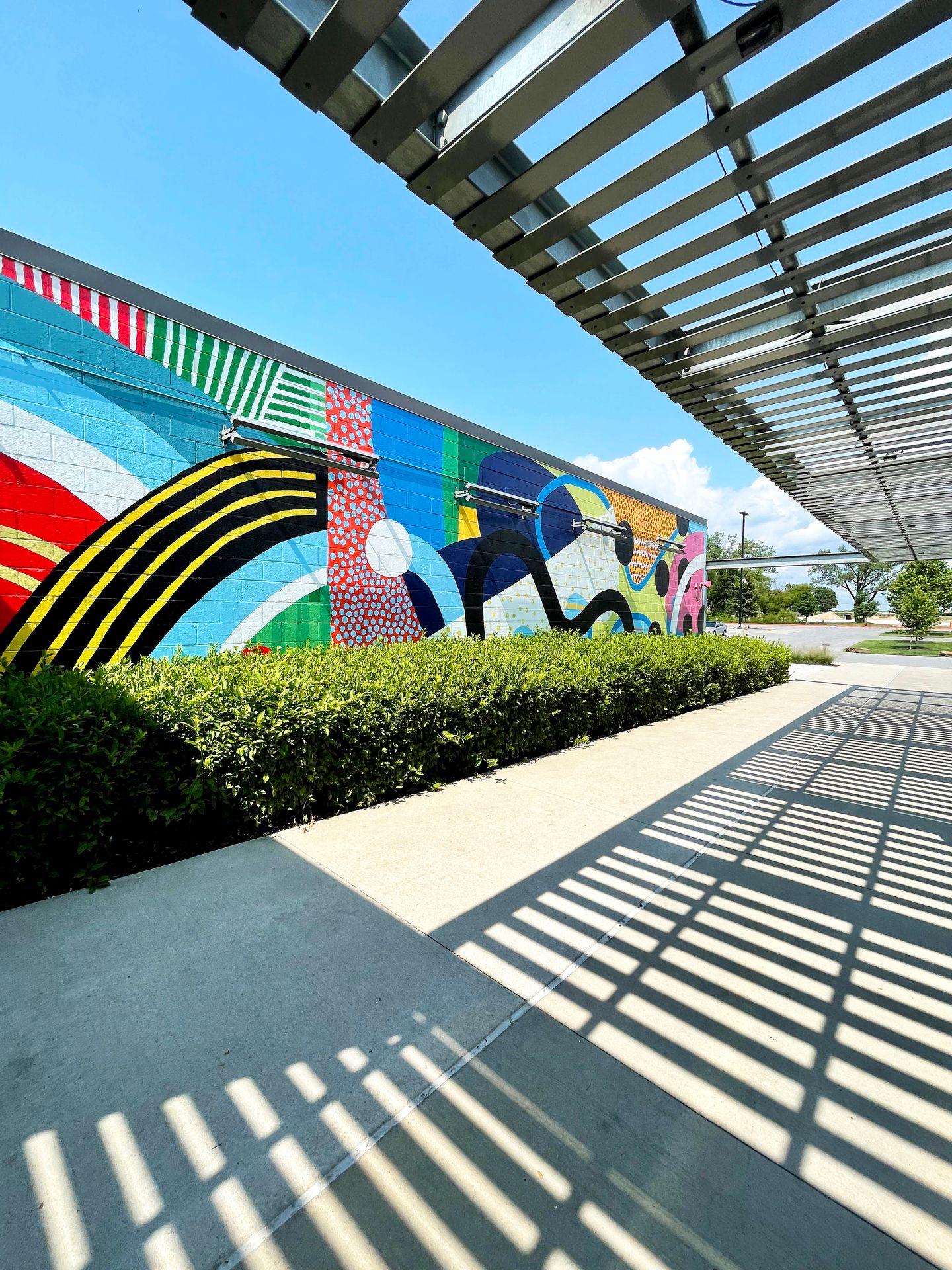A colorful, abstract mural outside at the 8th Street Market.