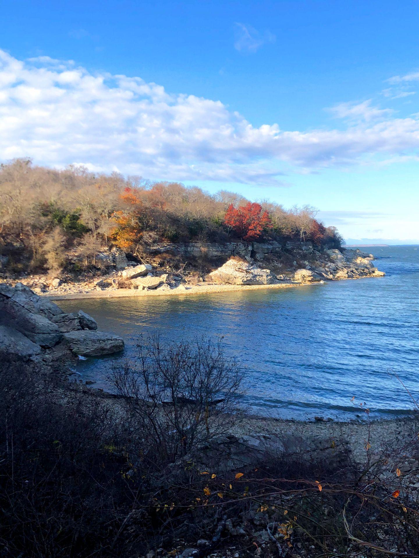 A store along Lake Texoma with colorful trees with red leaves.