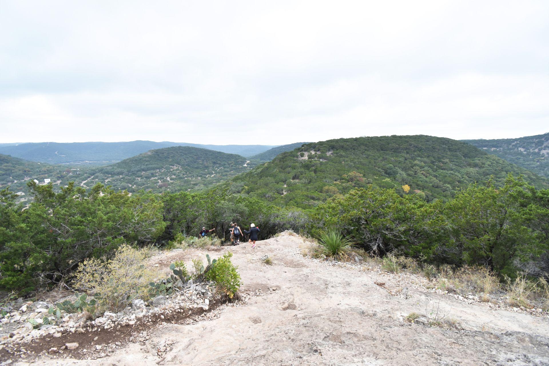 Some hikers going down the Mt Baldy trail with an amazing view of surrounding hills.