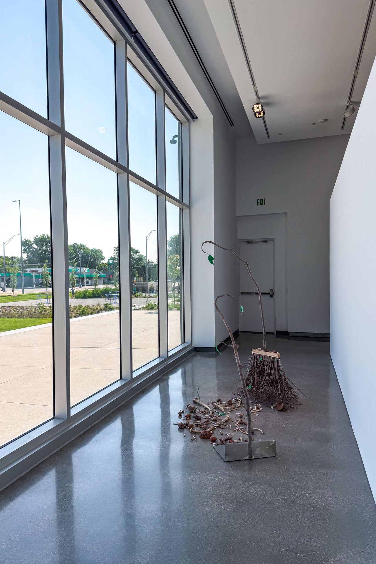 Art next to floor to ceiling windows inside the Museum of Nebraska Art