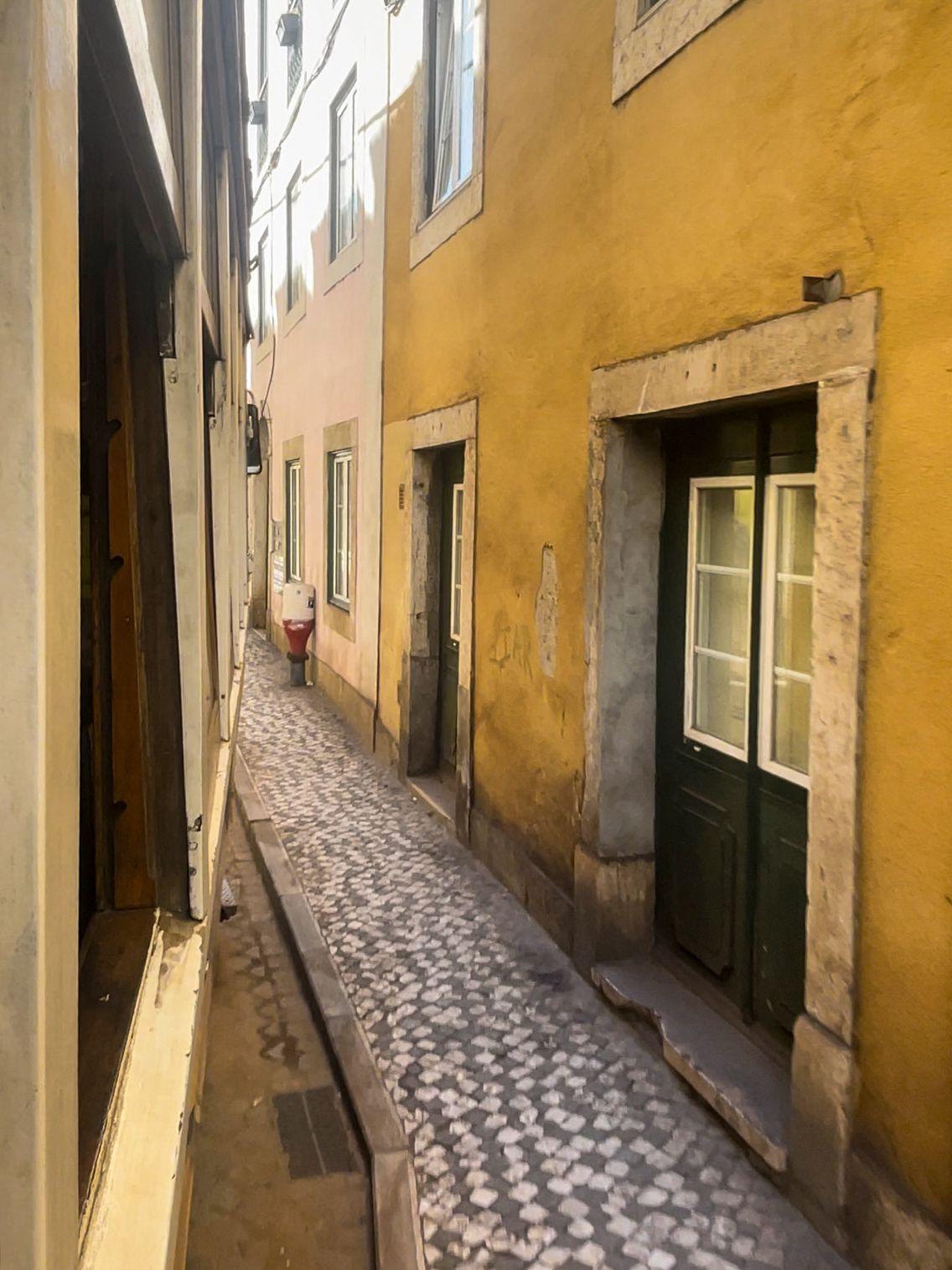 A view from the tram, which is very close to buildings with yellow walls