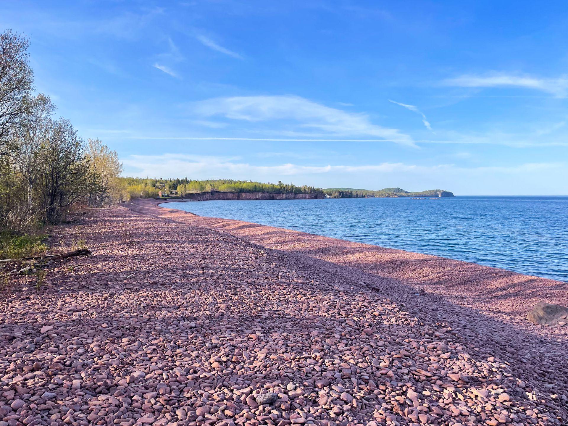 A rocky beach made up entirely of pinkish rocks.