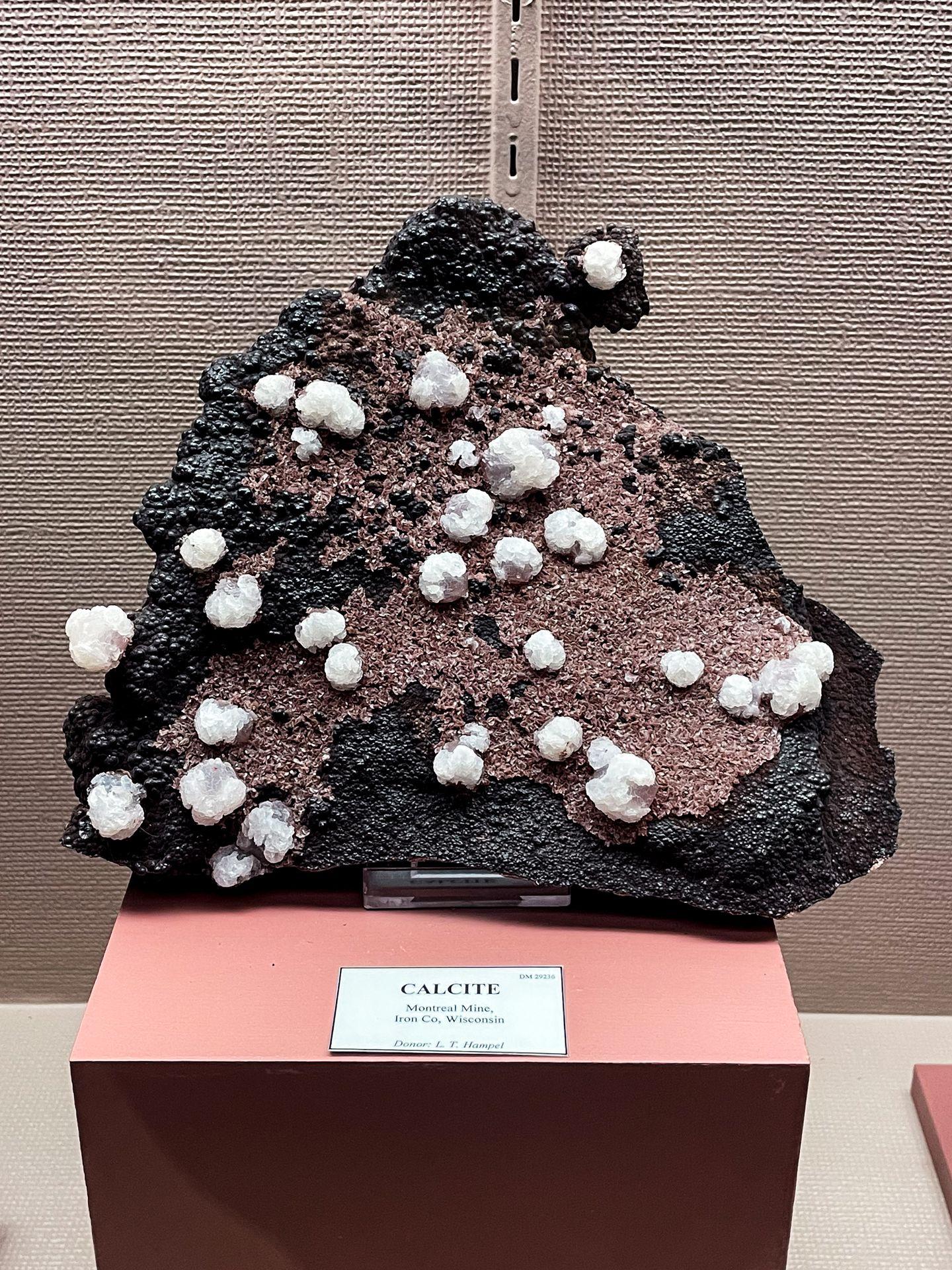A giant mineral that is black and red with bits of white throughout the rock