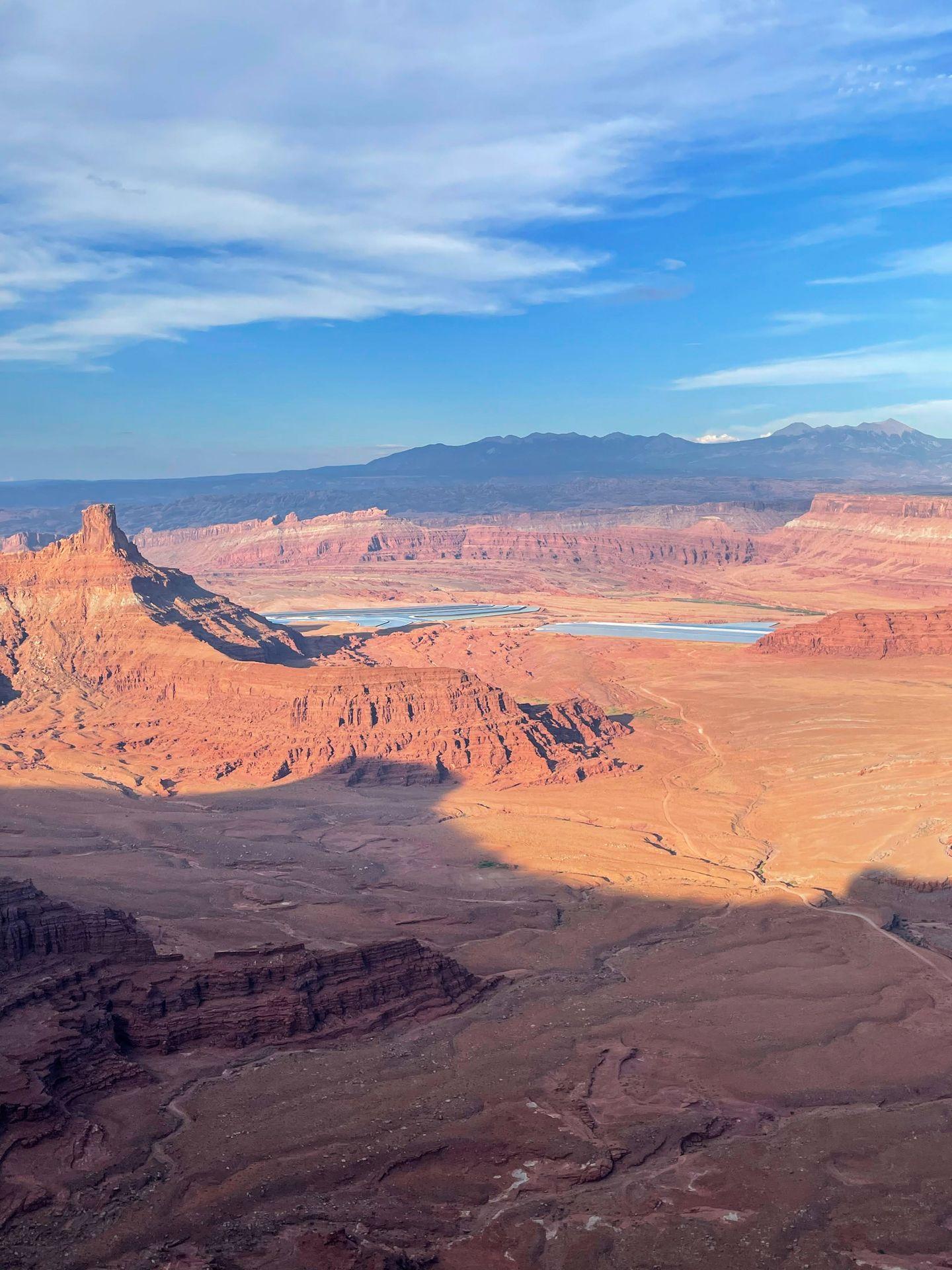 Neon, blue potash ponds in the distance from Dead Horse Point State Park
