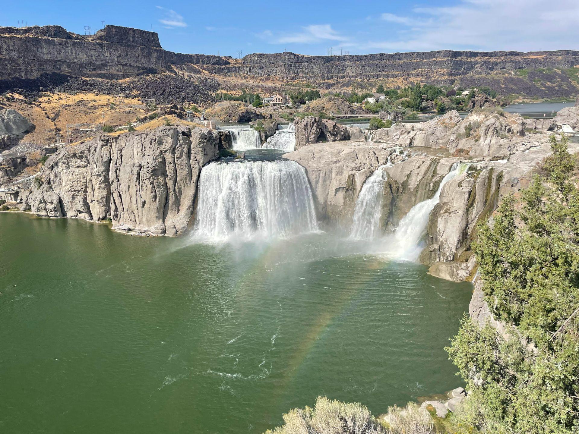 A view of Shoshone Falls with a rainbow near the falls.
