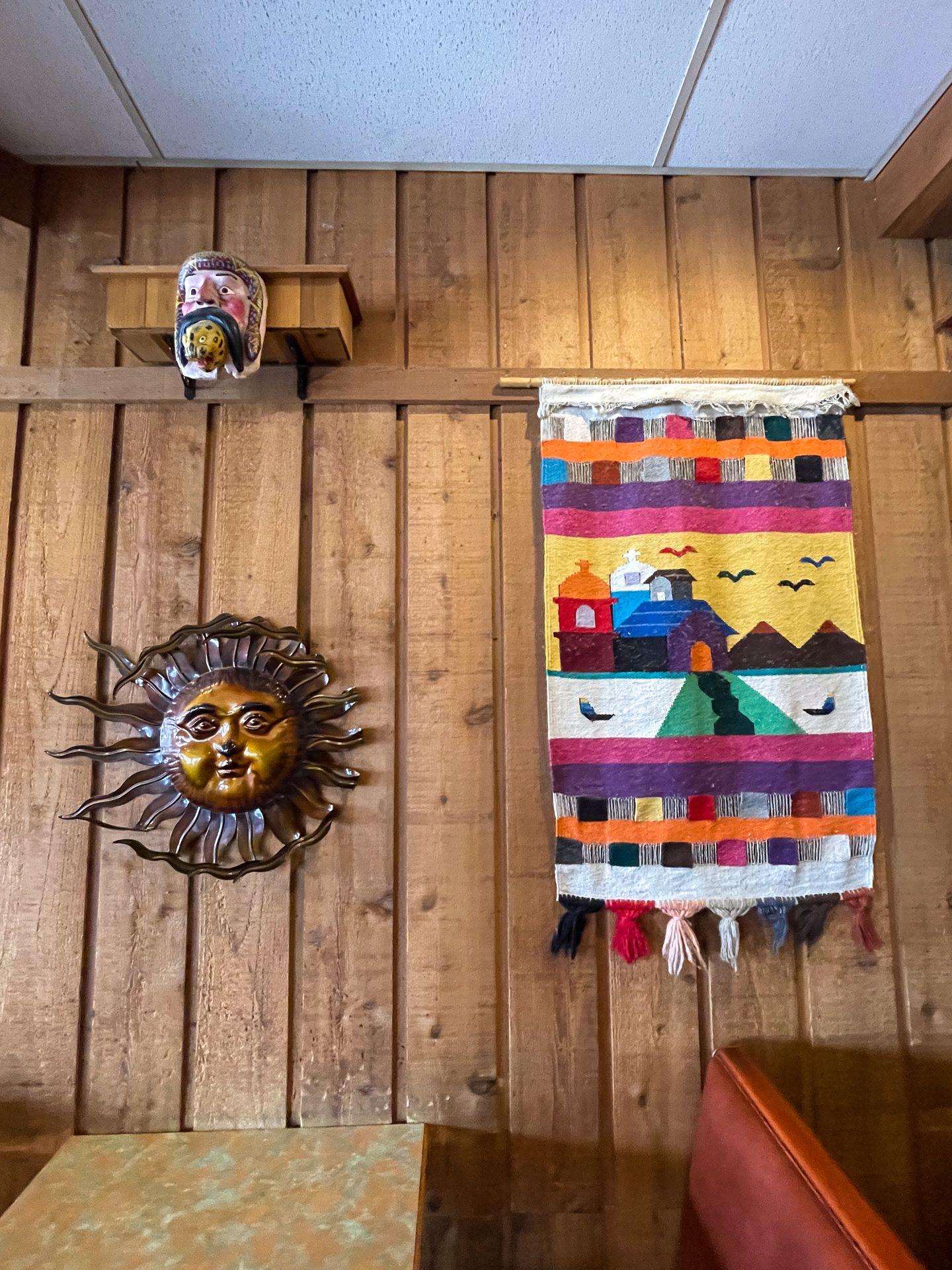 A wall with colorful artwork at Bravor Burrito