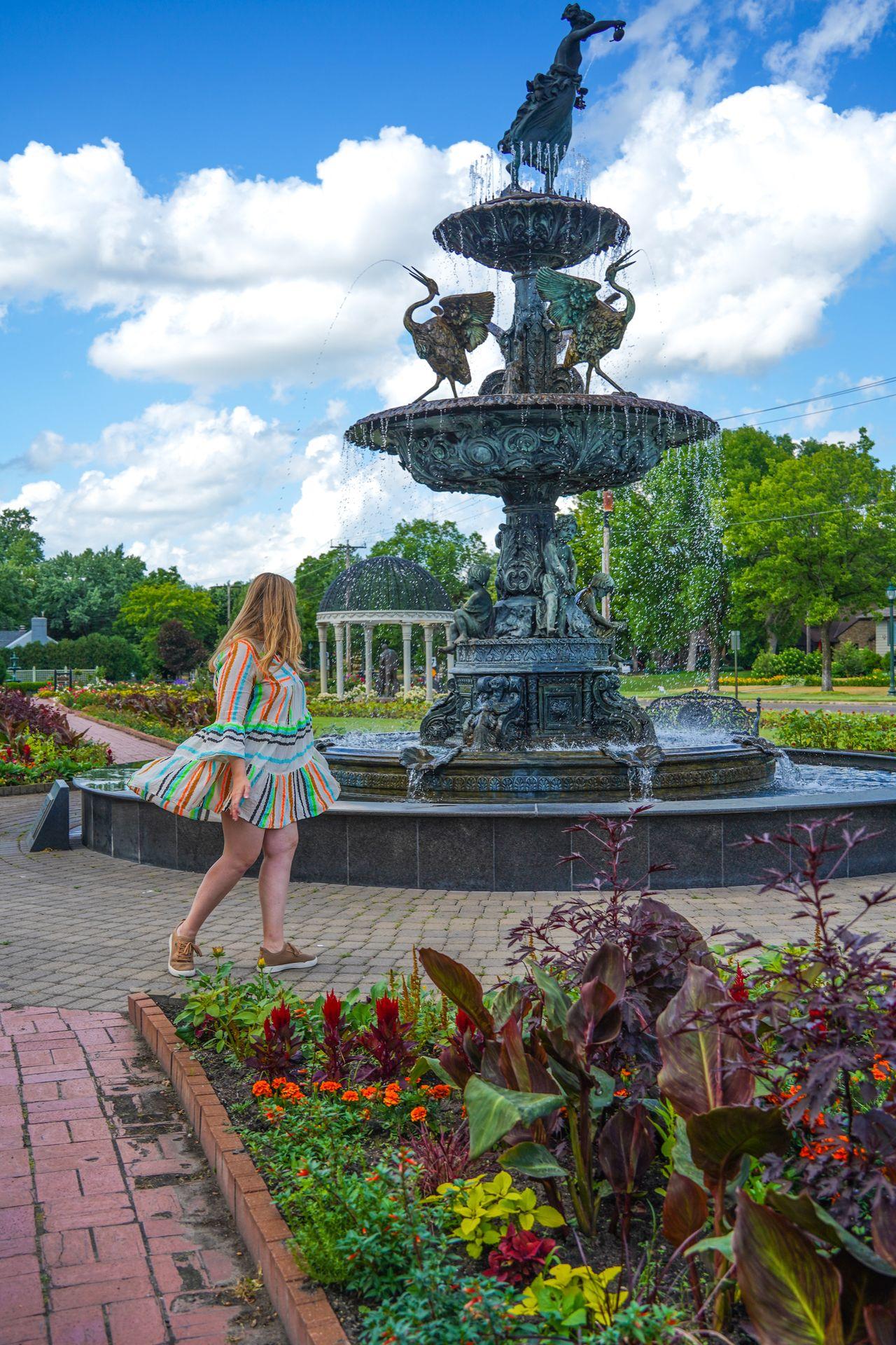 Lydia walking near a fountain at Munsinger Gardens