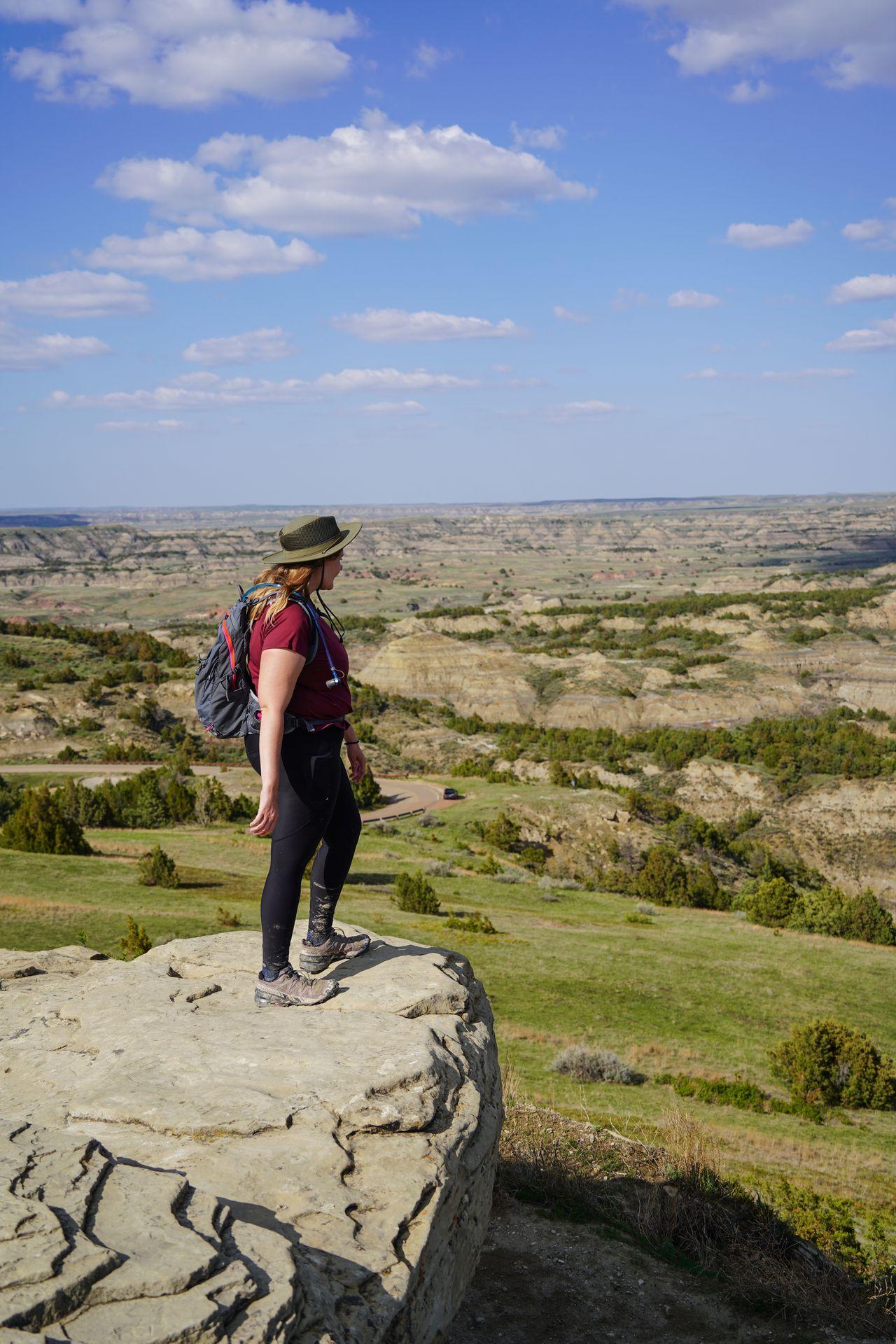 Lydia standing on a rock looking out at a valley on the Buck Hill Trail