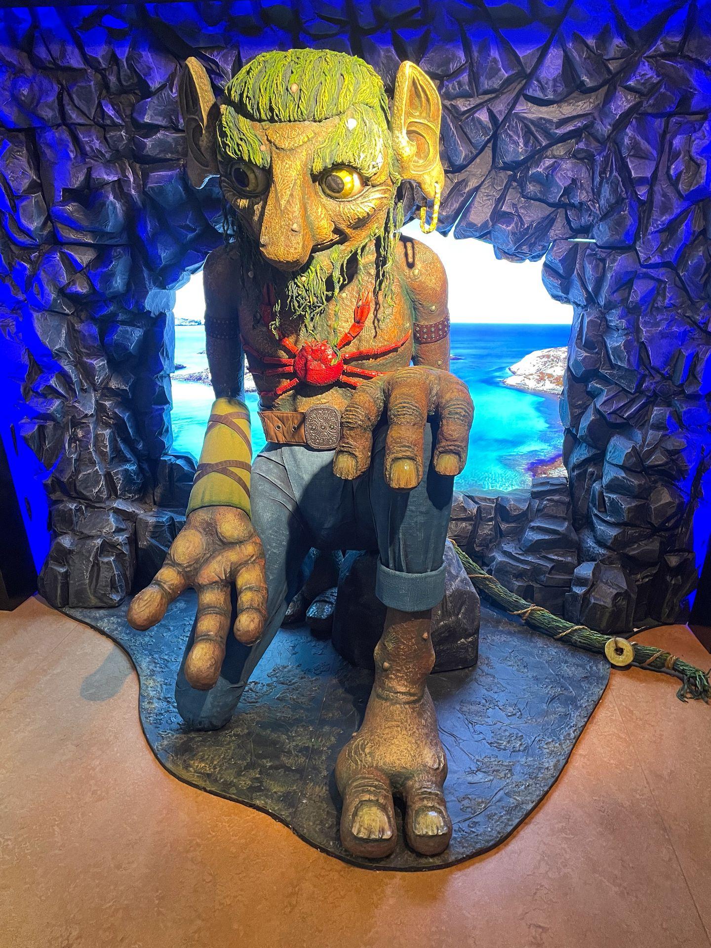 A life-sized troll with a lobster on it's chest