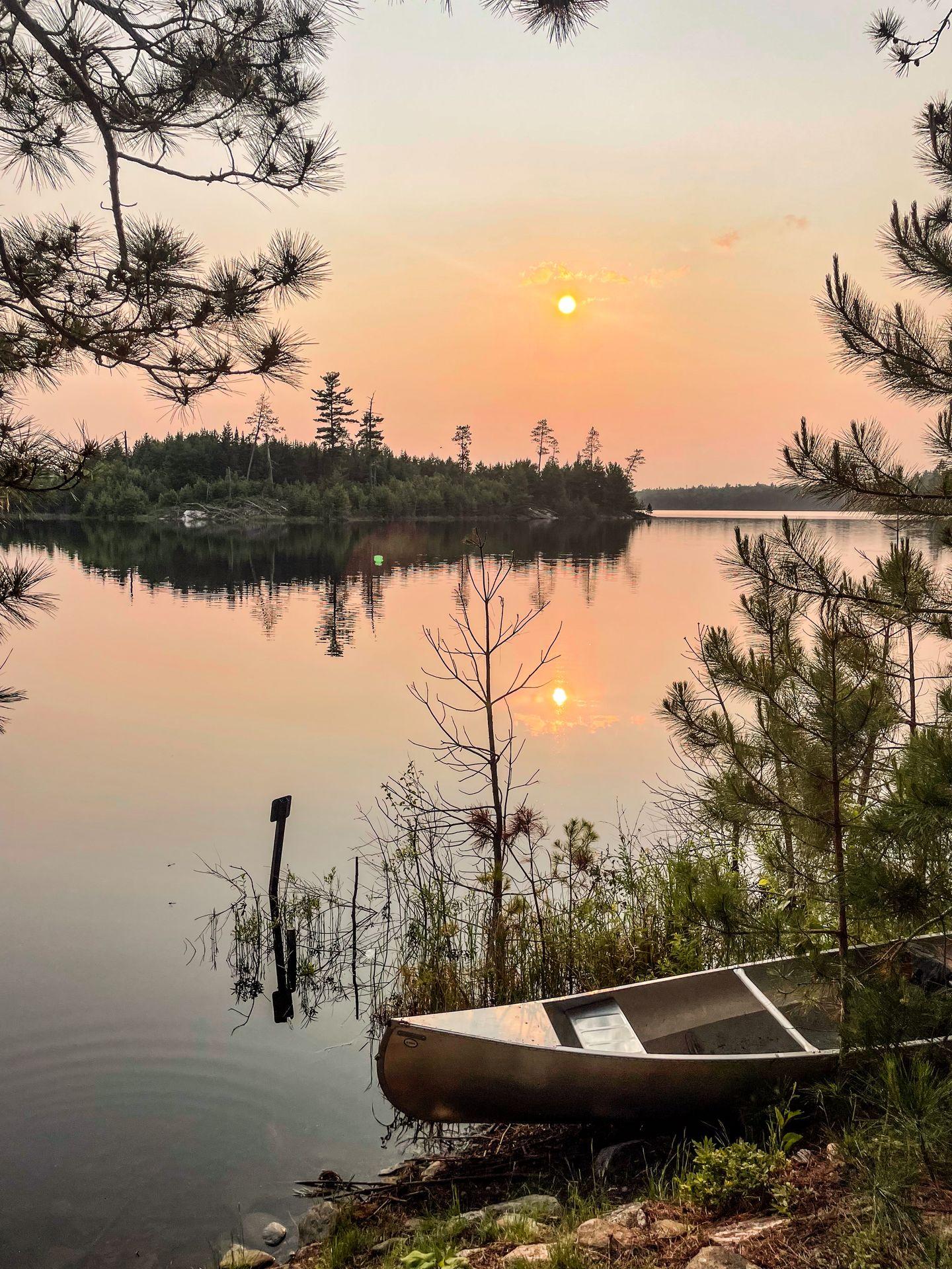 A canoe on a shore at sunset in the backcountry of Voyaguers National Park
