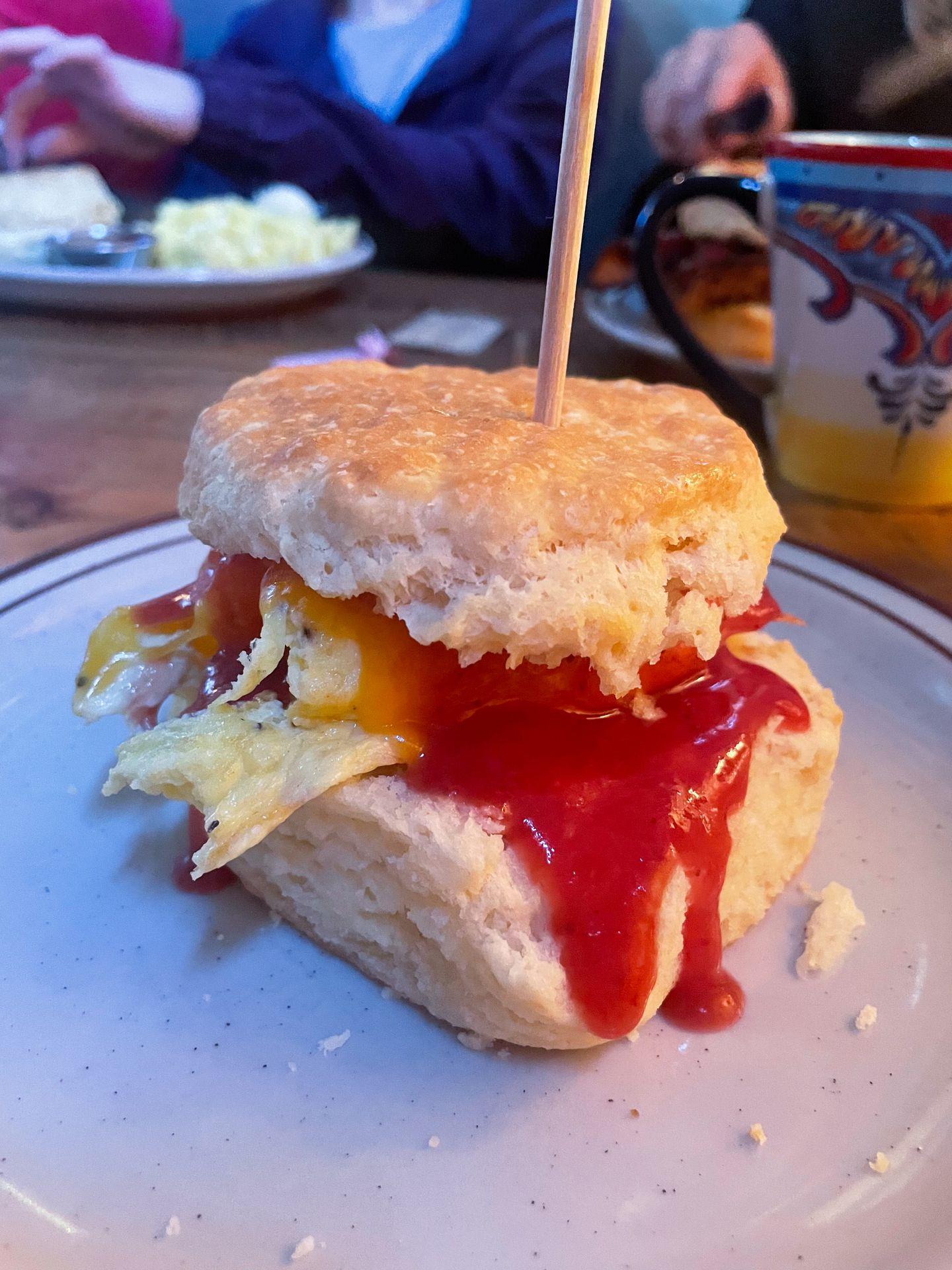 A biscuit sandwich with egg and jam.