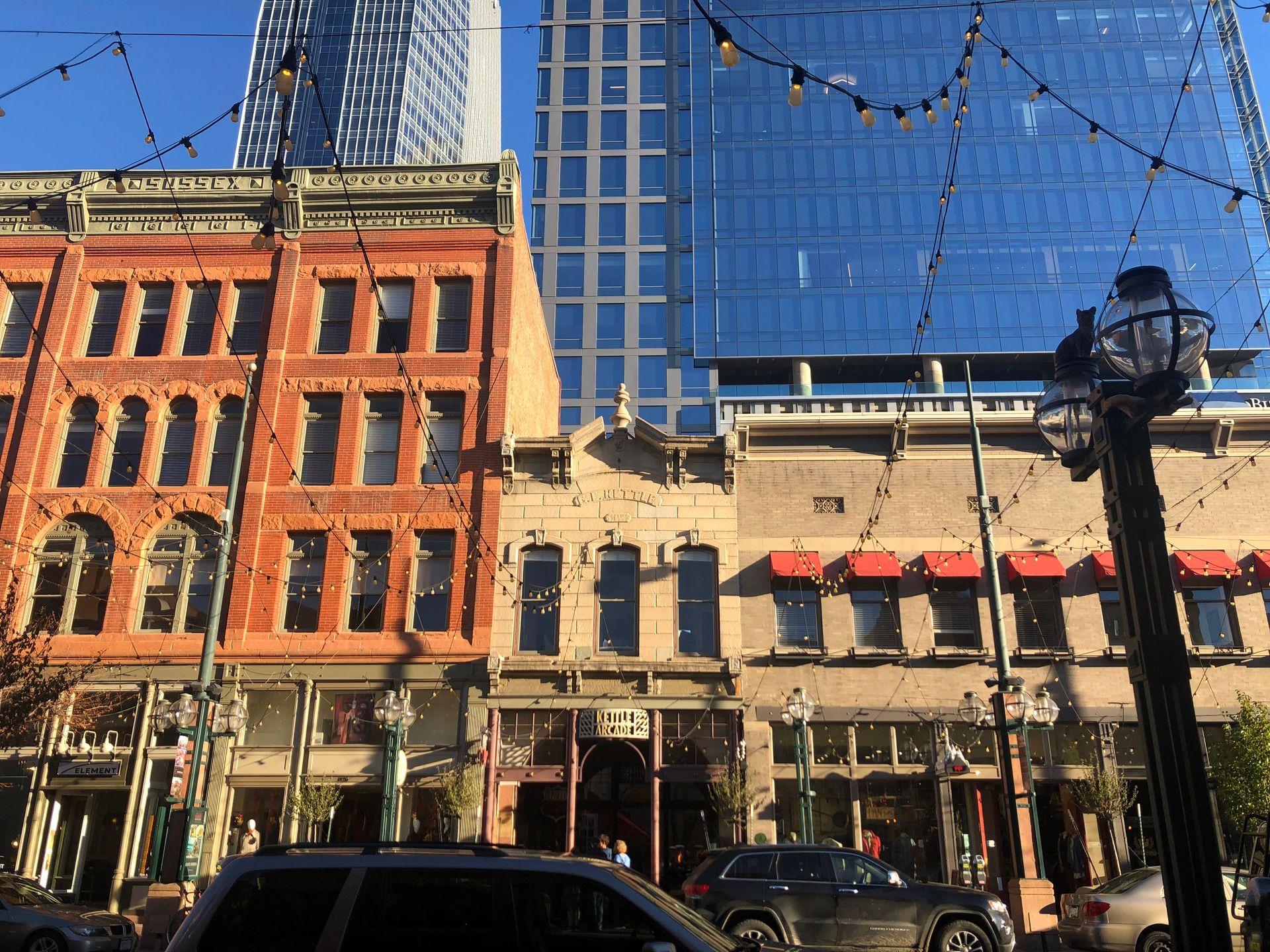 A city block with hanging string lights at Larimer Square.