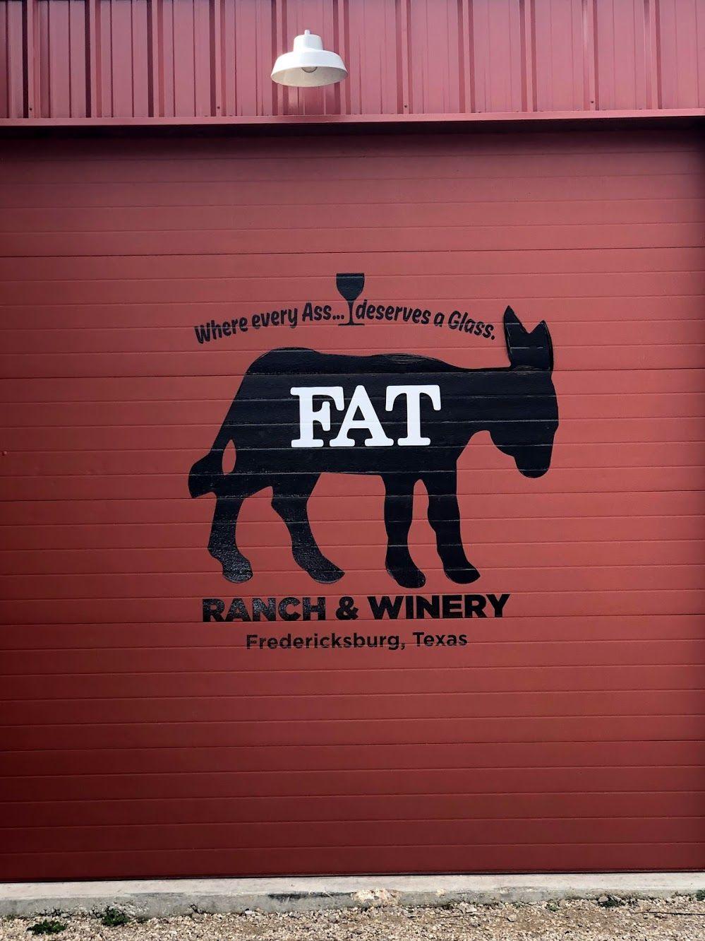 The logo for Fat Ass Ranch & Winery on a red garage door.
