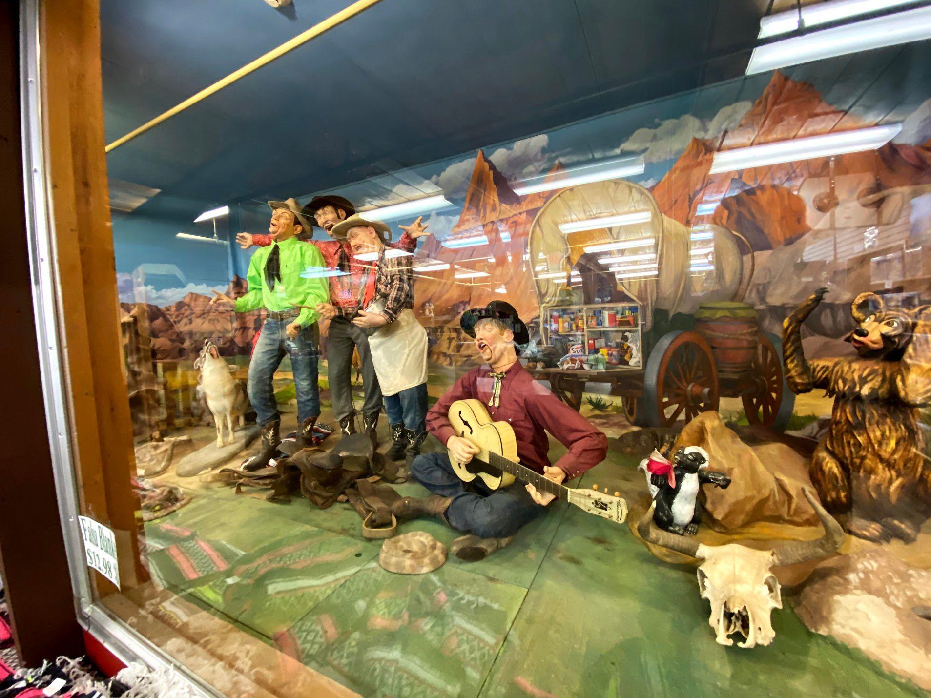 Animatronic cowboys playing music behind glass inside of Wall Drug.