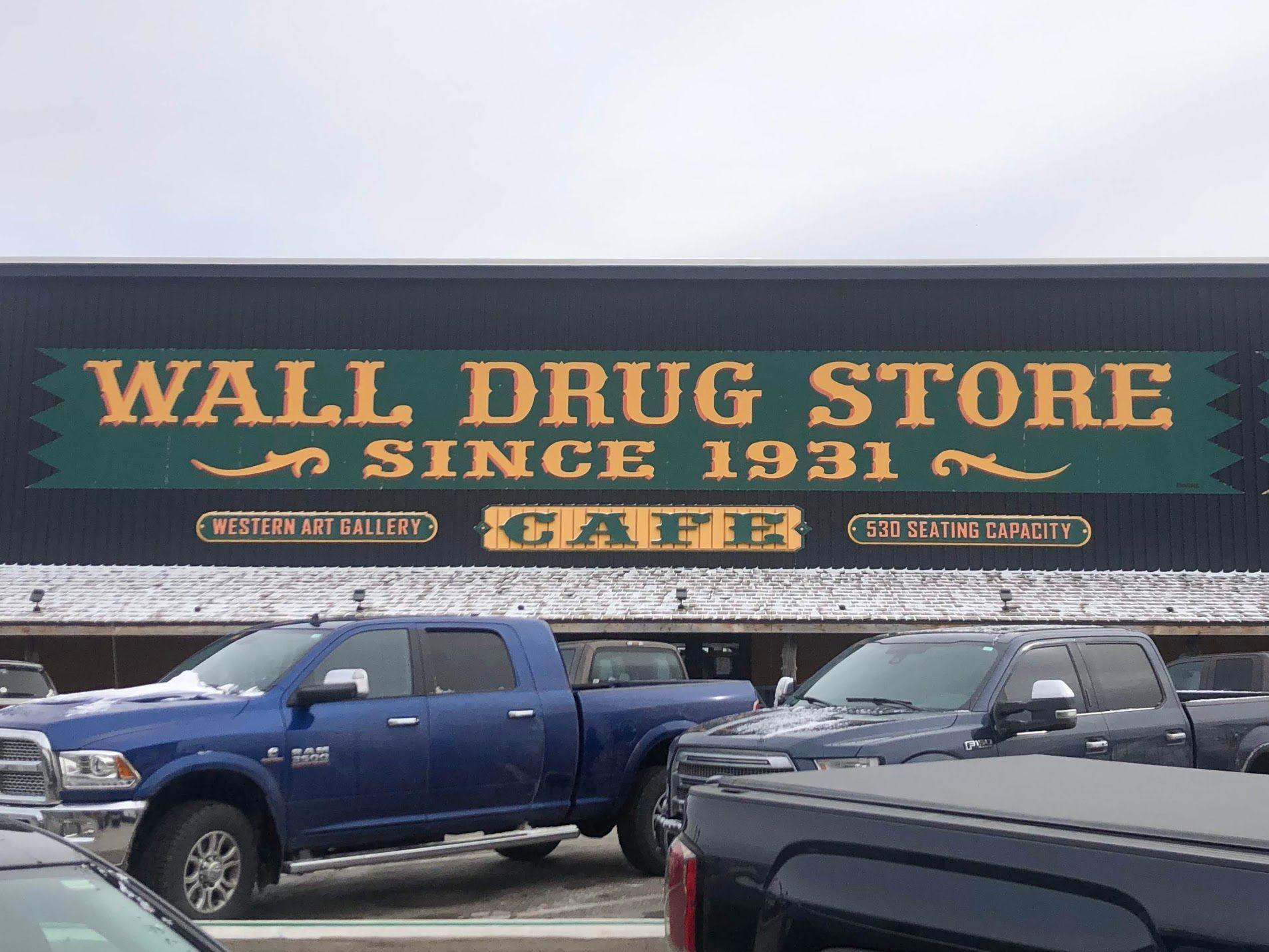 The exterior of Wall Drug Store. The sign reads 'Wall Drug Store, Since 1931, Western Art Gallery, Cafe, 530 Seating Capacity'