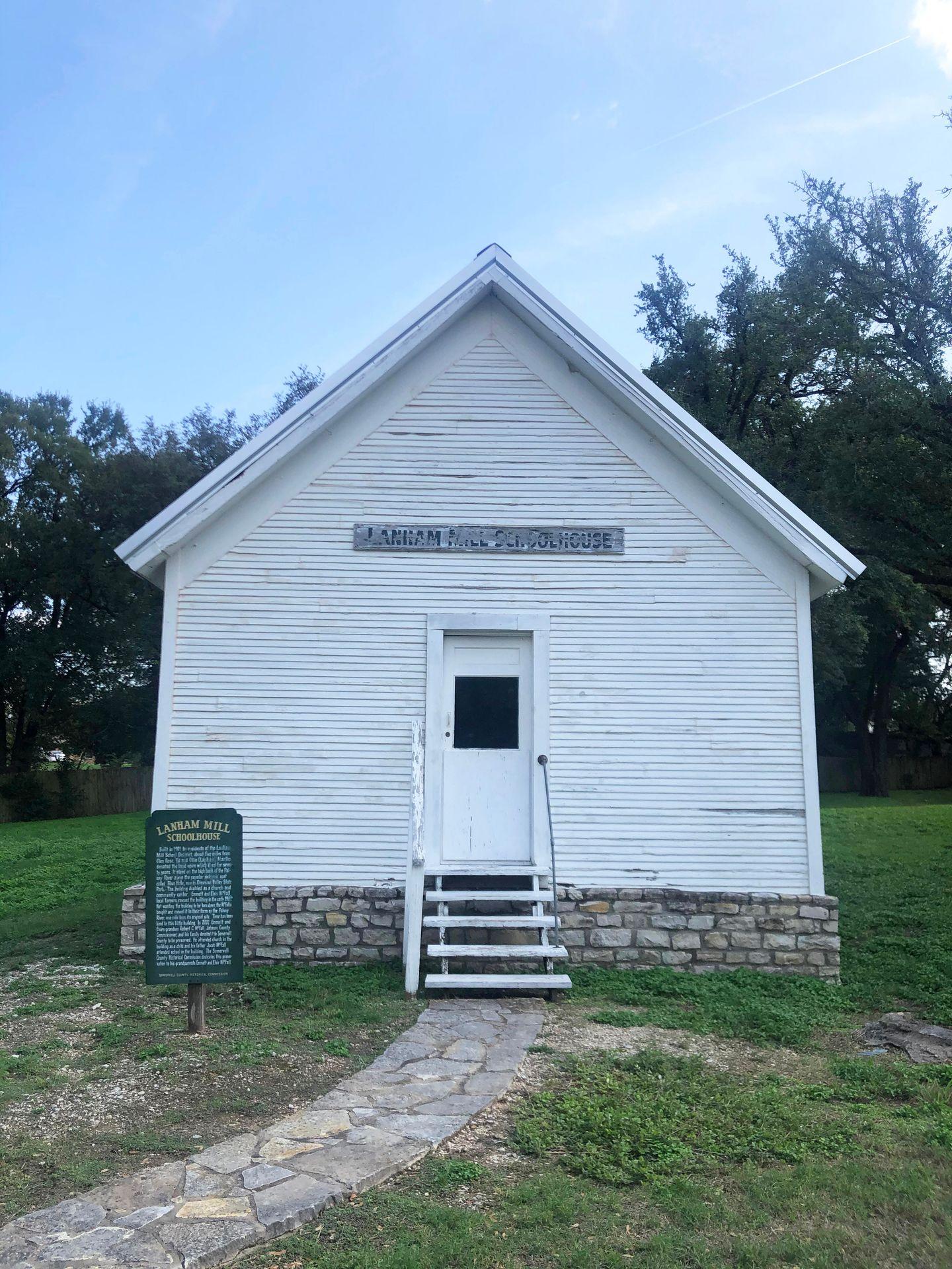 A white schoolhouse in the Paluxy Heritage Park.